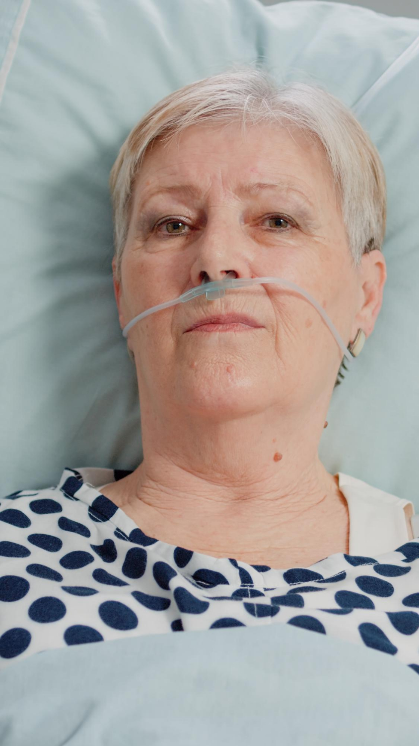 A stressed aged woman in a hospital ward | Source: Freepik