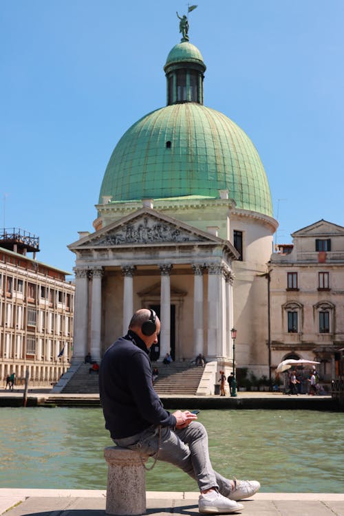 A man sitting by the canal | Source: Pexels