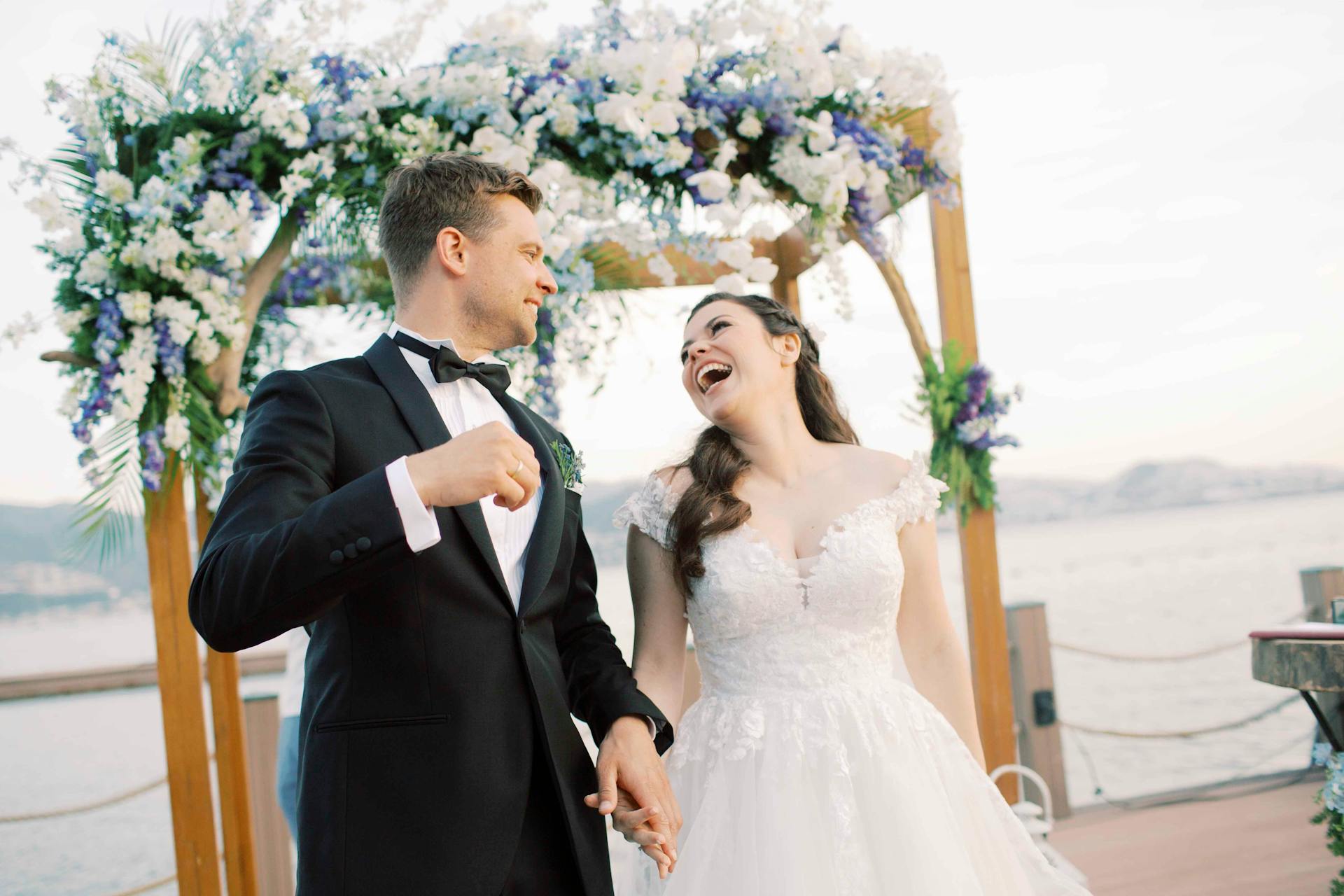 A bride and groom holding hands and laughing | Source: Pexels