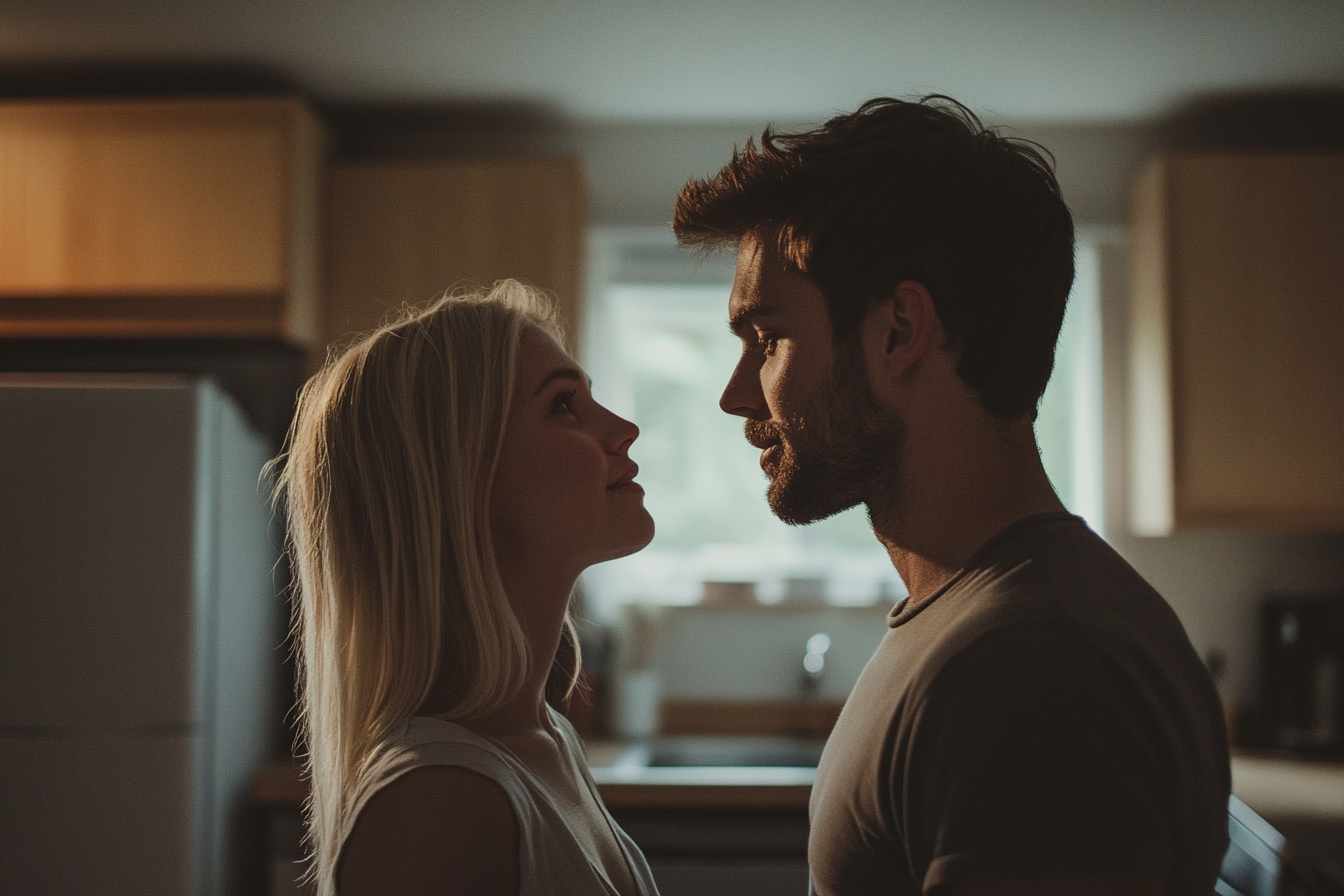 Two people sharing a romantic moment in a kitchen | Source: Midjourney