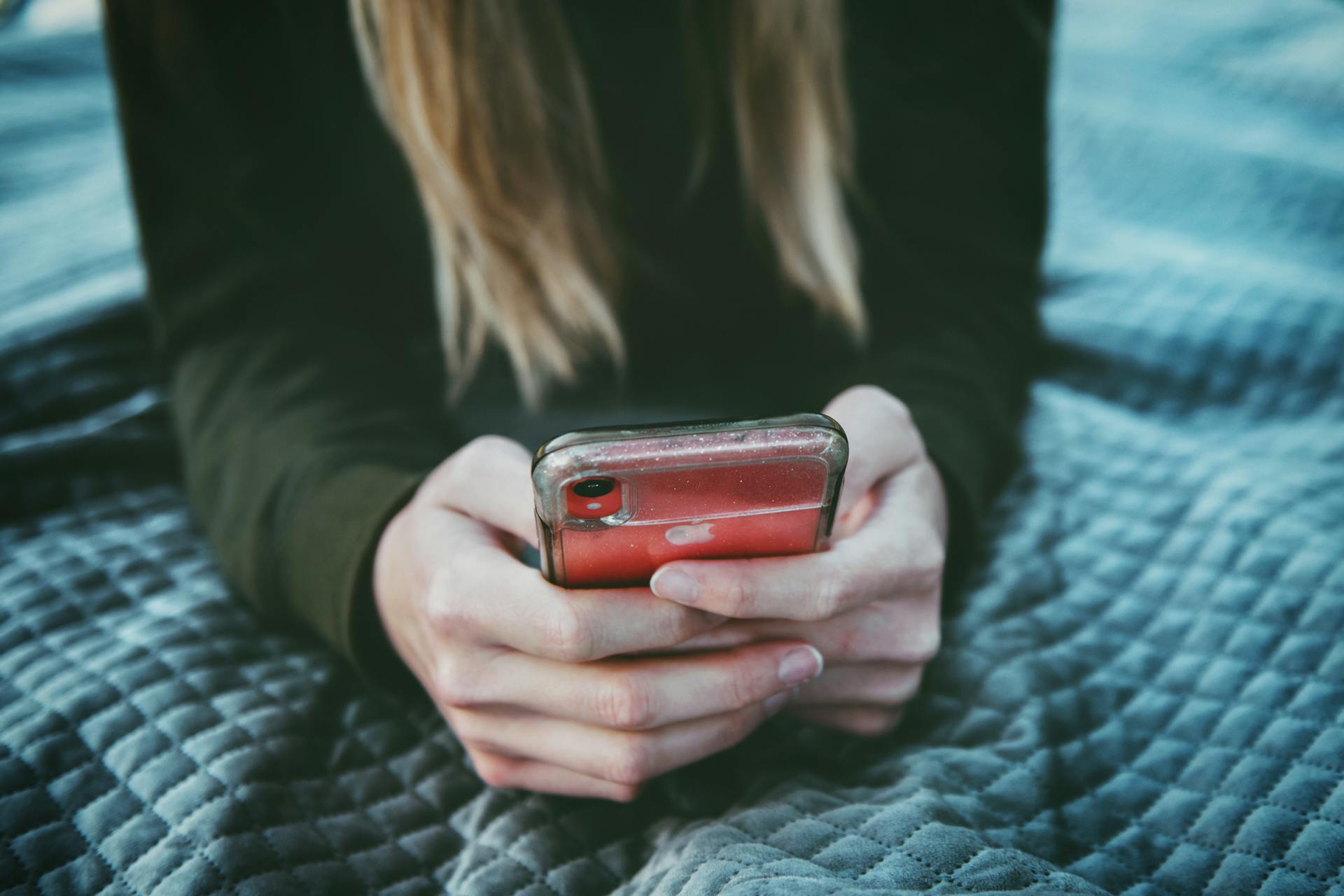 Close-up cropped shot of a young woman using a phone | Source: Pexels