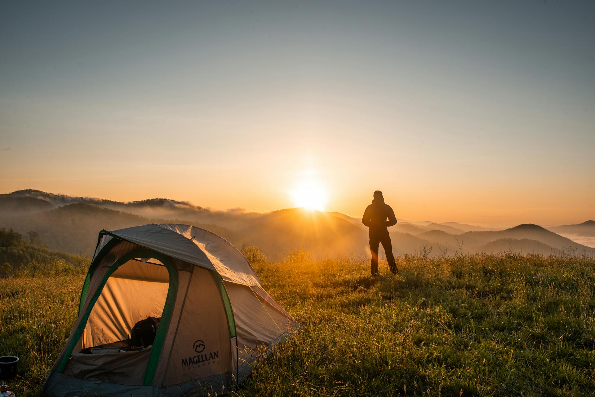 A person standing near a camping tent | Source: Pexels