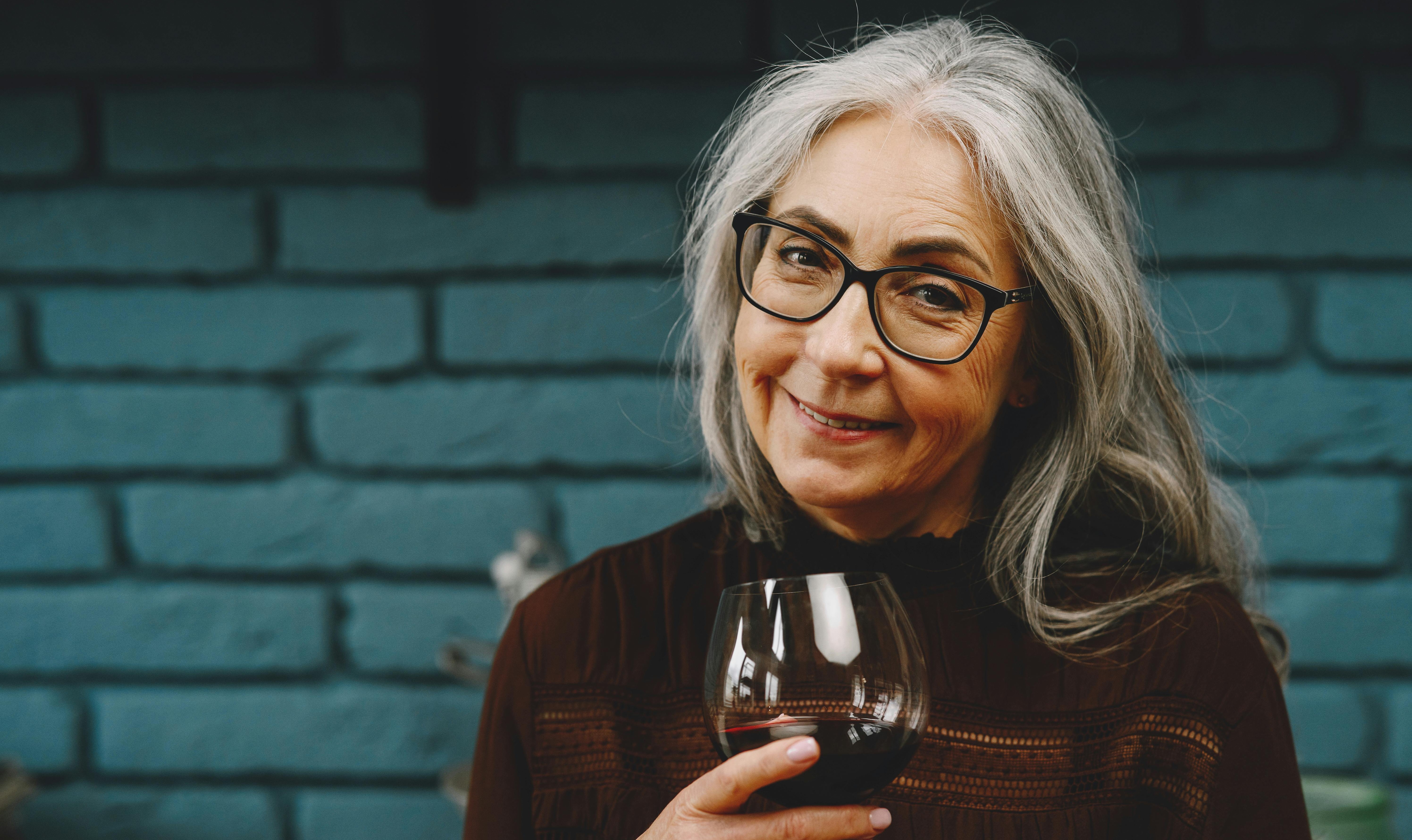 A happy woman holding a beverage | Source: Pexels