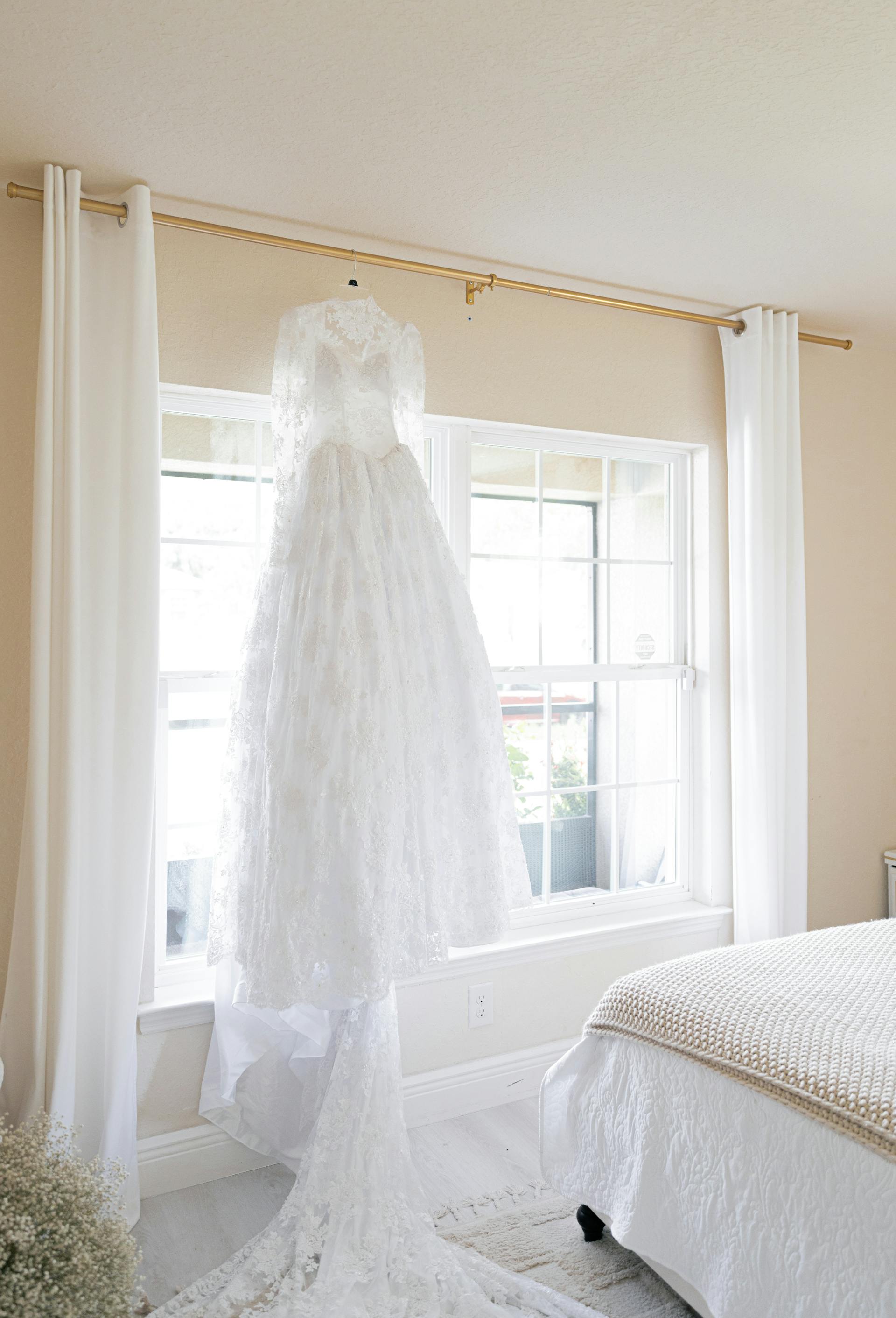 A wedding dress hanging by a window | Source: Pexels