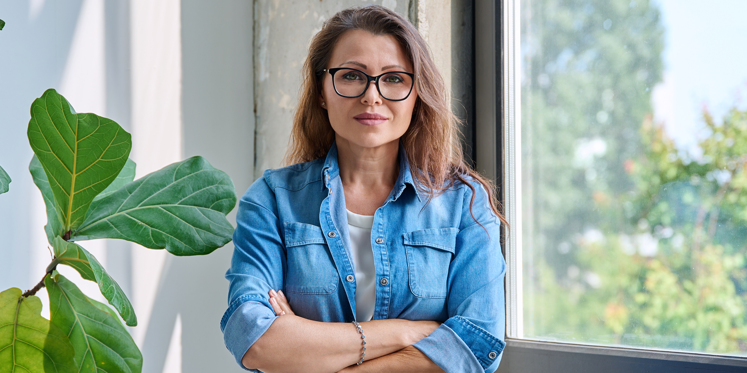 A woman standing with folded arms | Source: Shutterstock