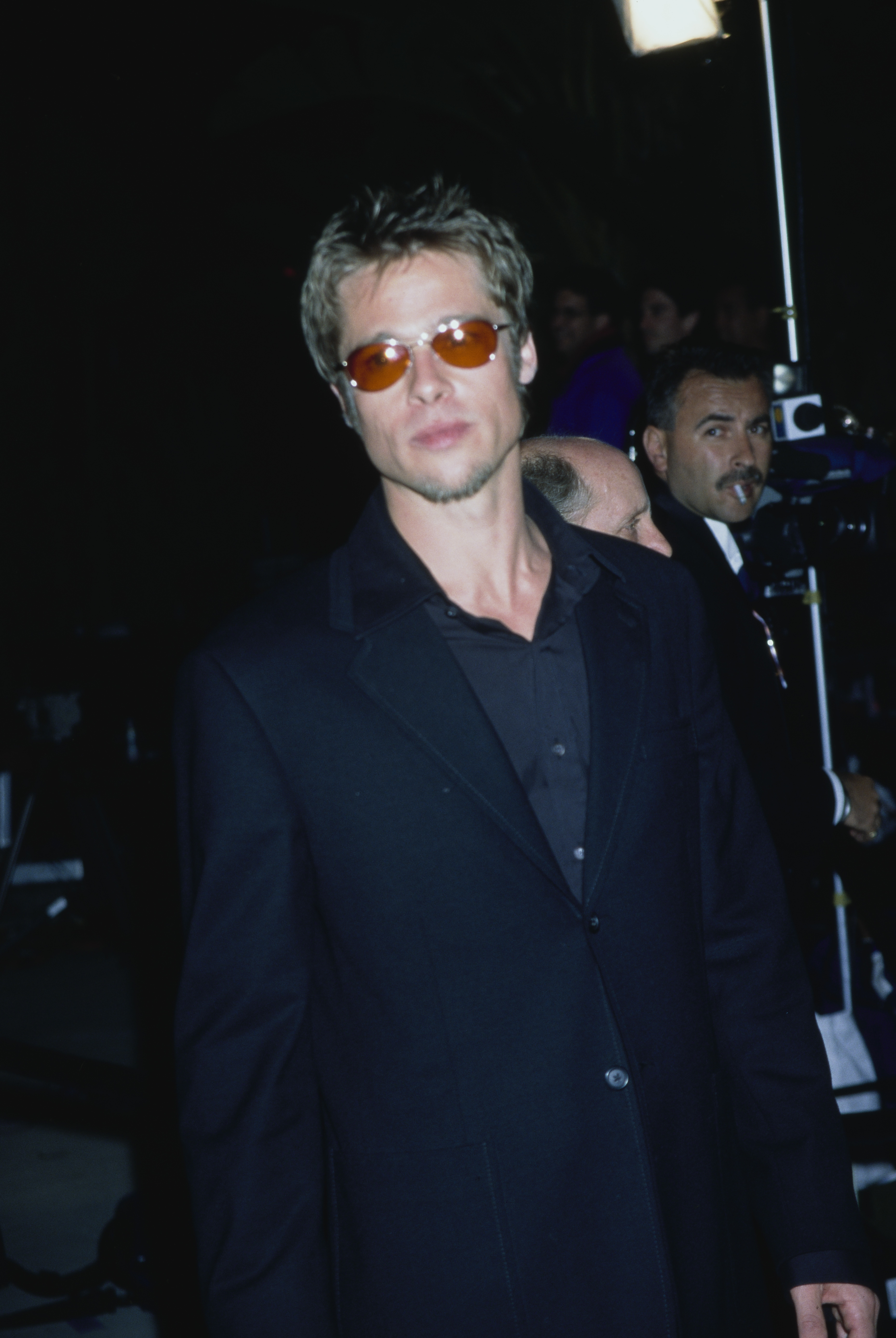 Brad Pitt wears orange-tinted shades and an all-black outfit at the Fifth Annual Vanity Fair Oscar Party at Morton's restaurant in Los Angeles, California on March 23, 1998.
