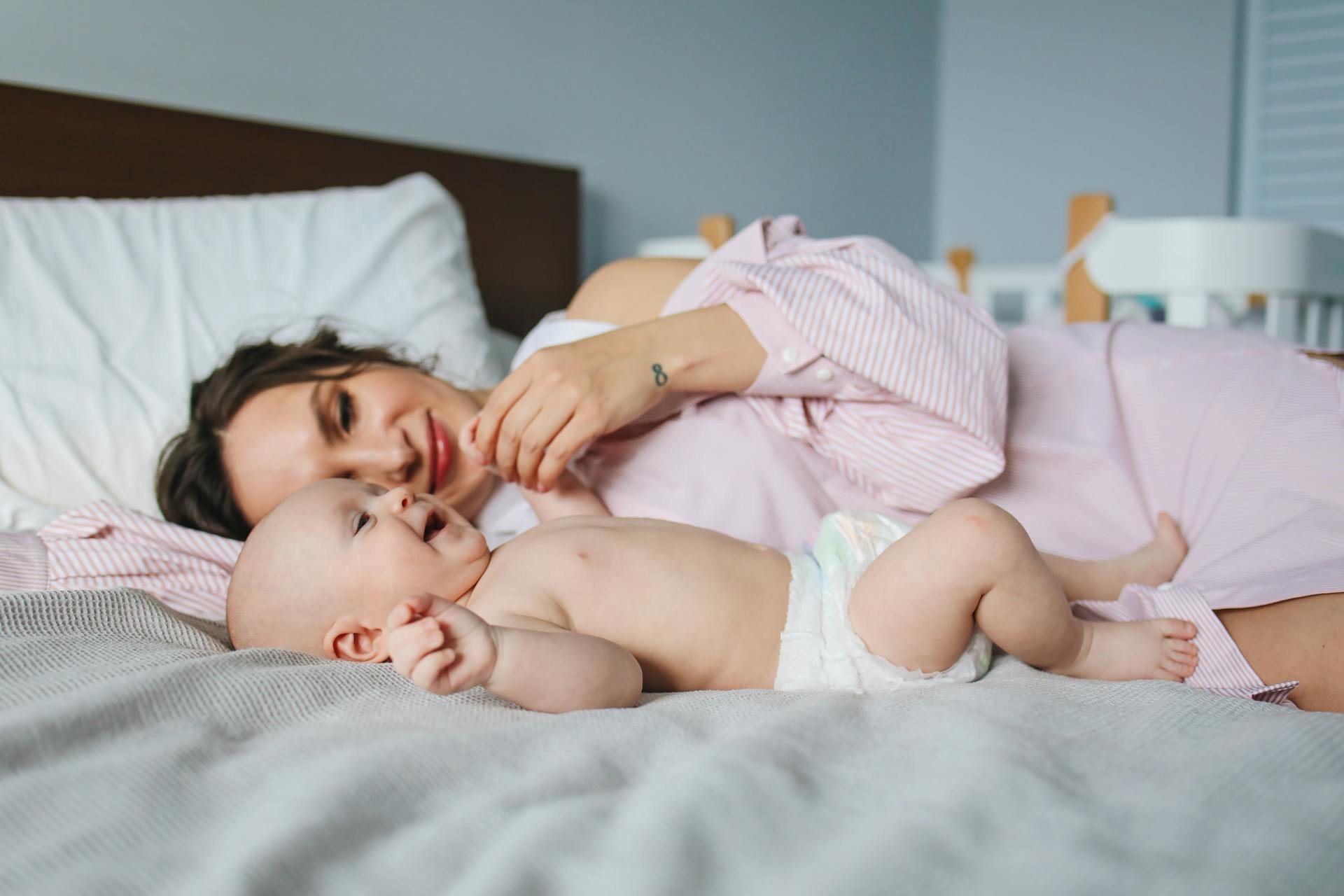 A woman cuddling a baby | Source: Pexels