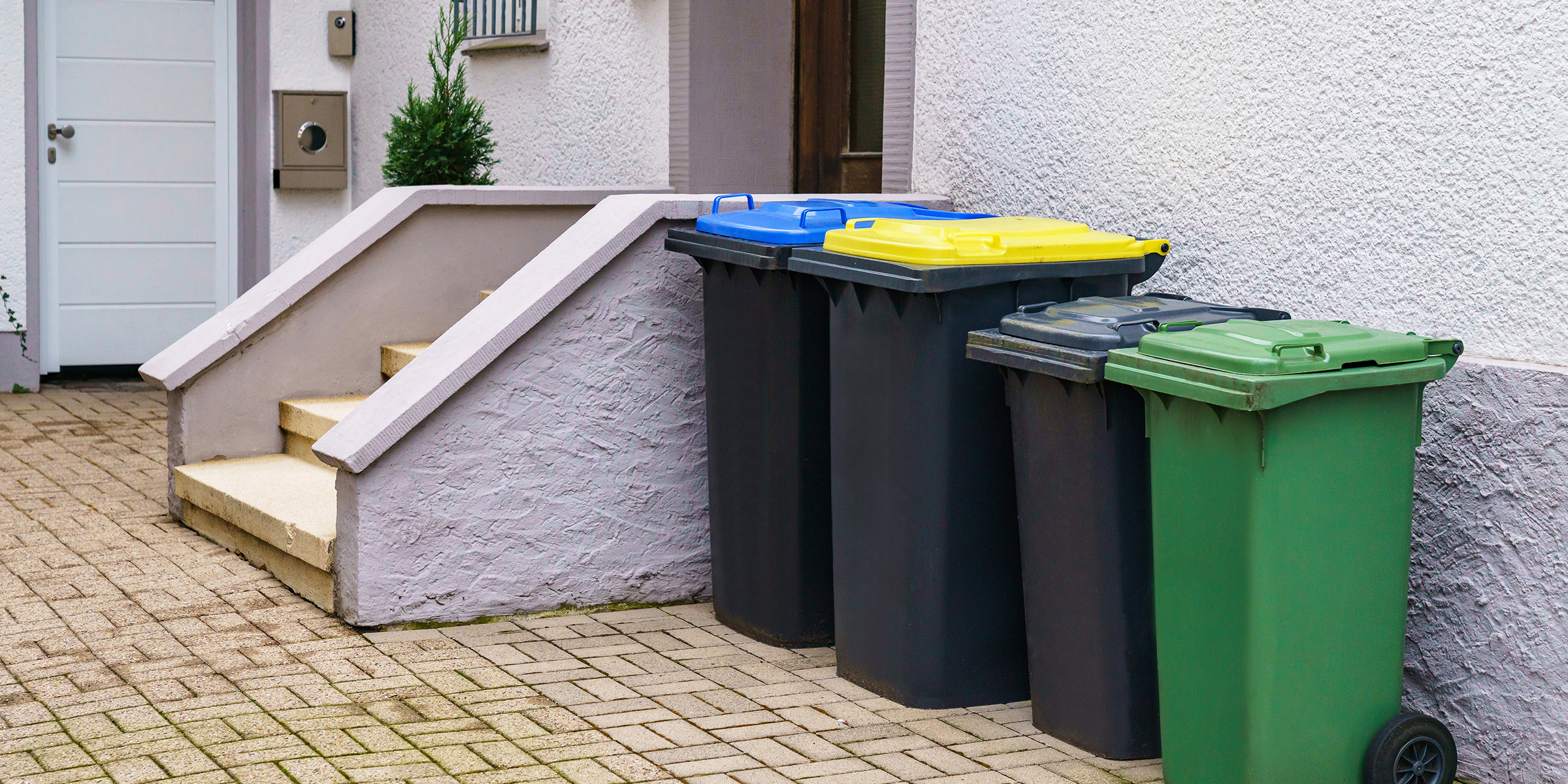 Trash bins outside a house | Source: Shutterstock