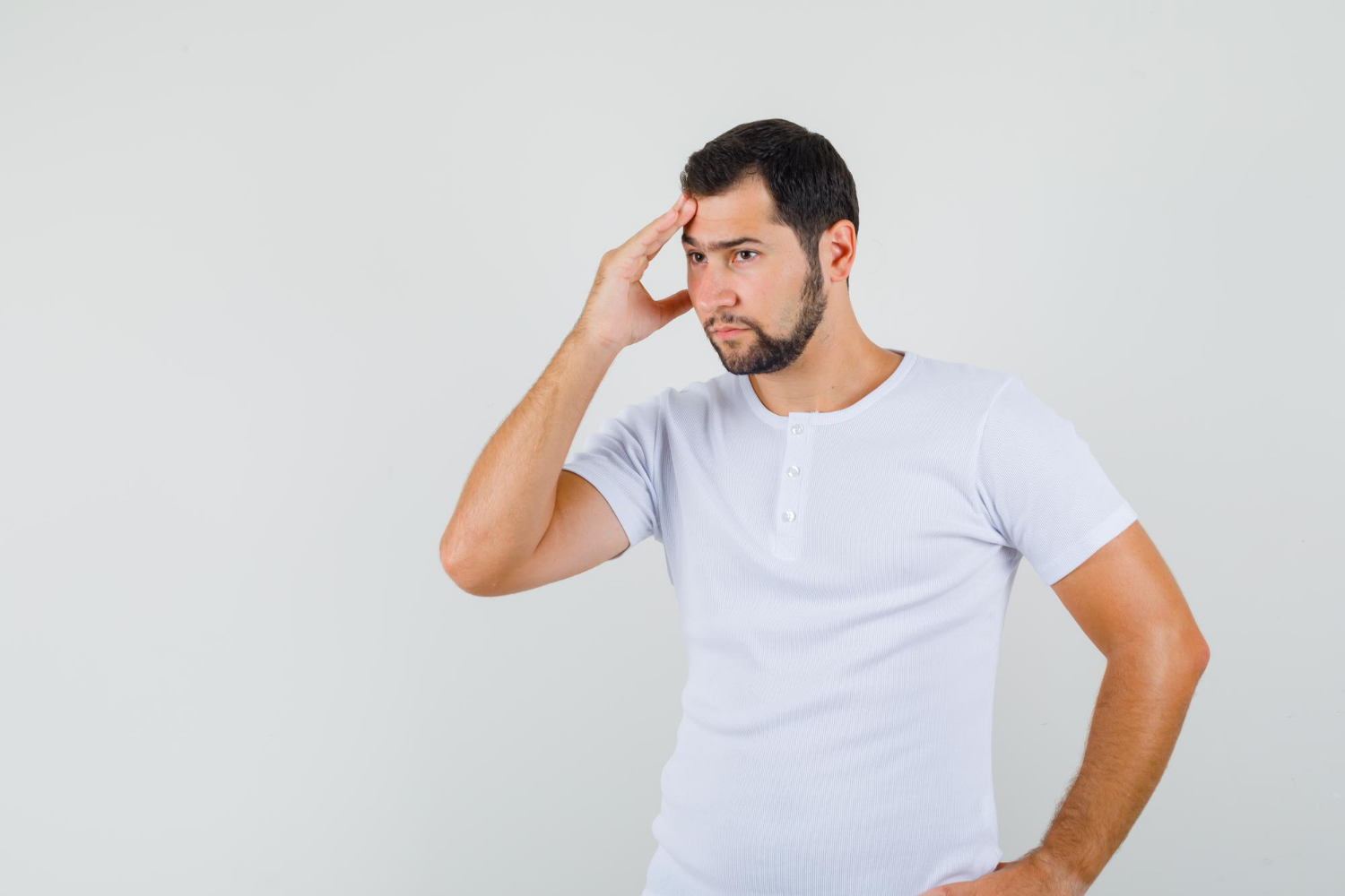 An anxious man with his hand on his forehead | Source: Freepik