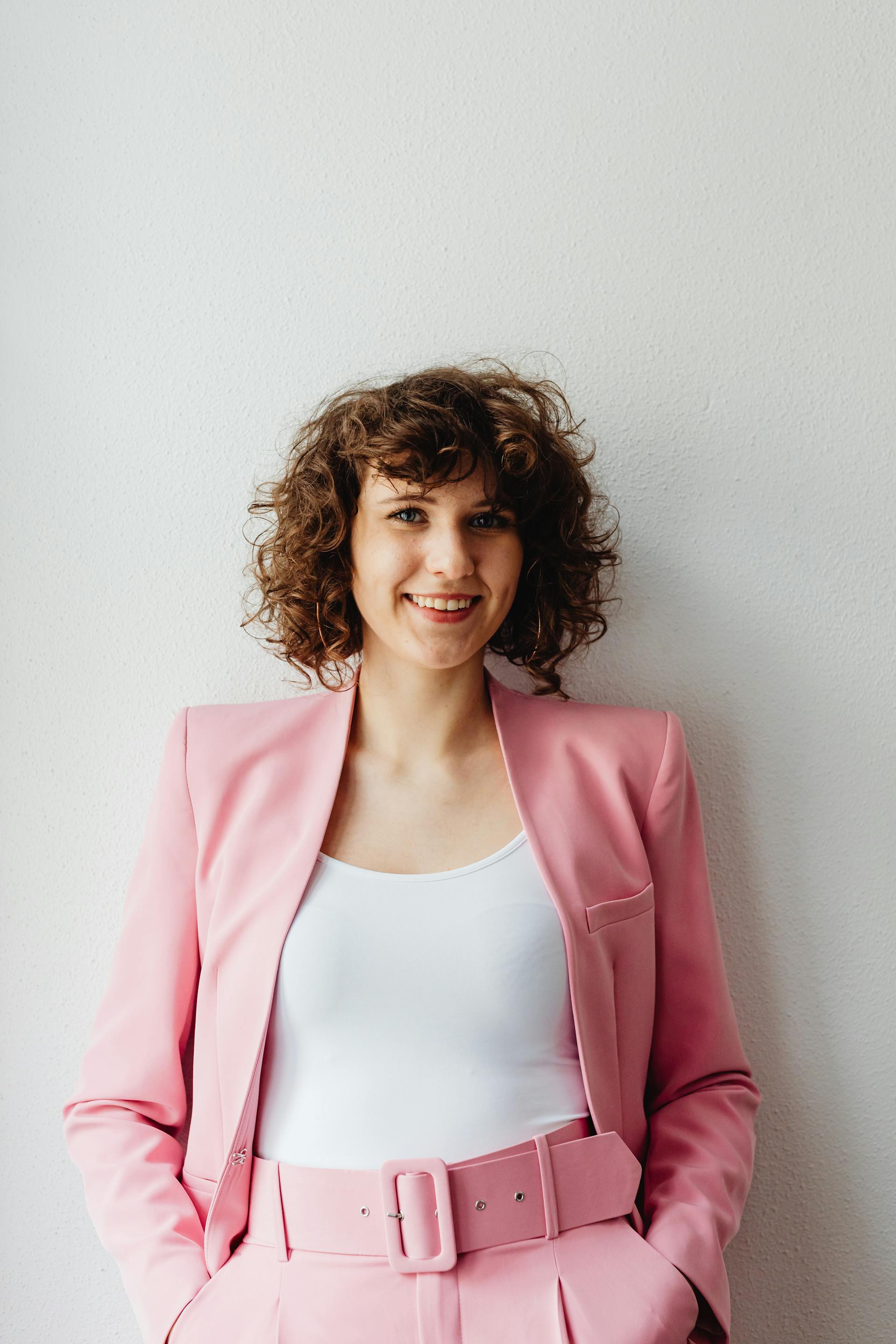 My Stepfather Told My Mom She Didn't Need Pretty Clothes Anymore – It Was His Biggest Mistake 10 A woman standing and smiling | Source: Pexels