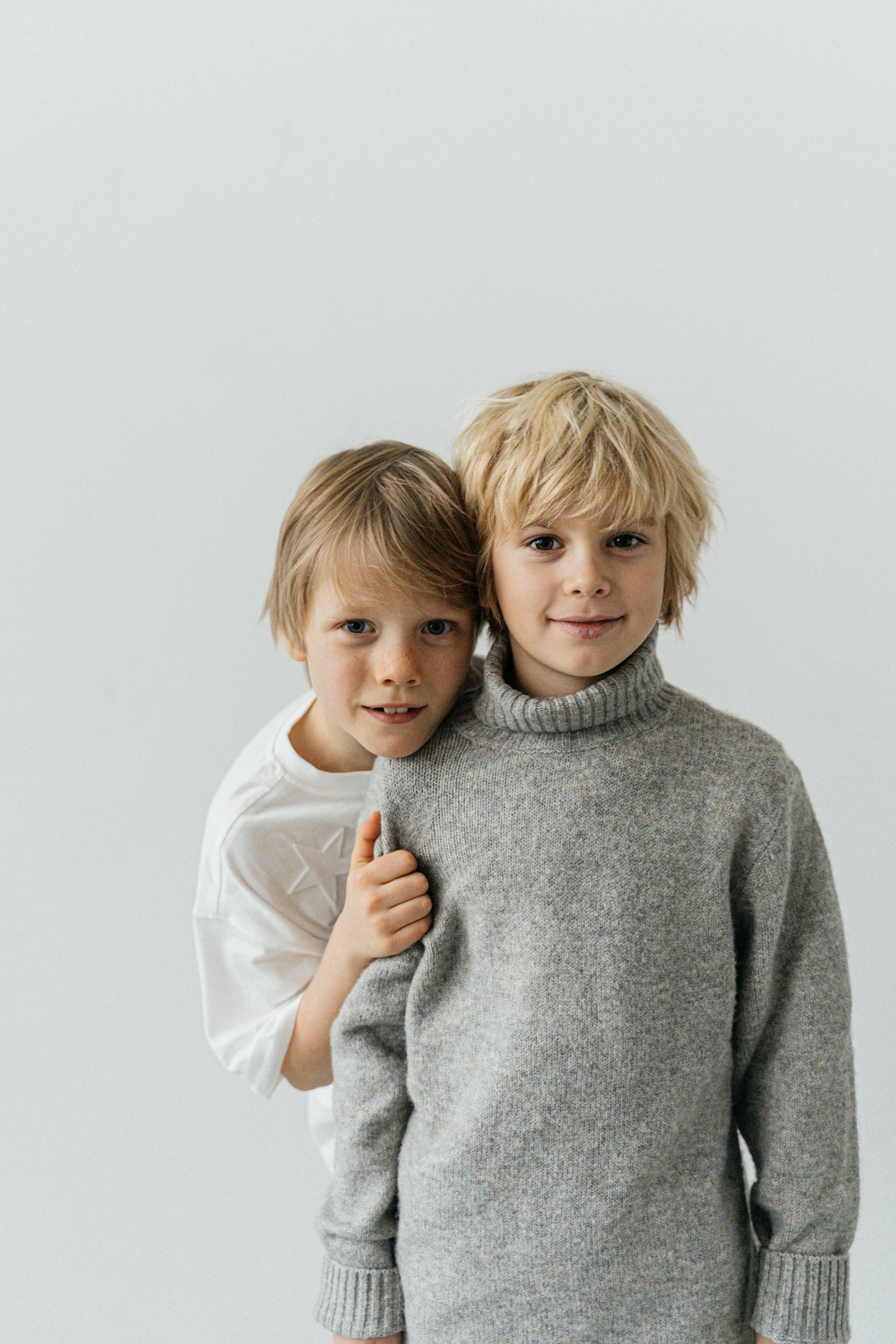 Two young boys posing in sweaters | Source: Pexels