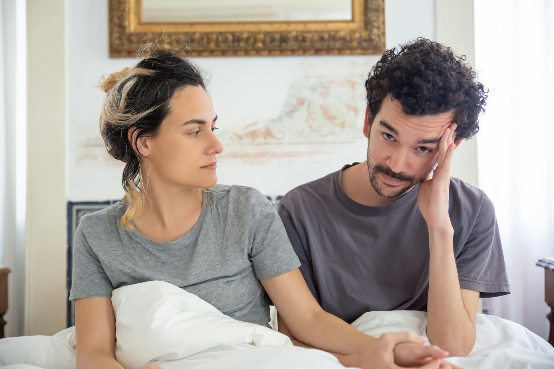 Couple having serious conversation in bed | Source: Pexels