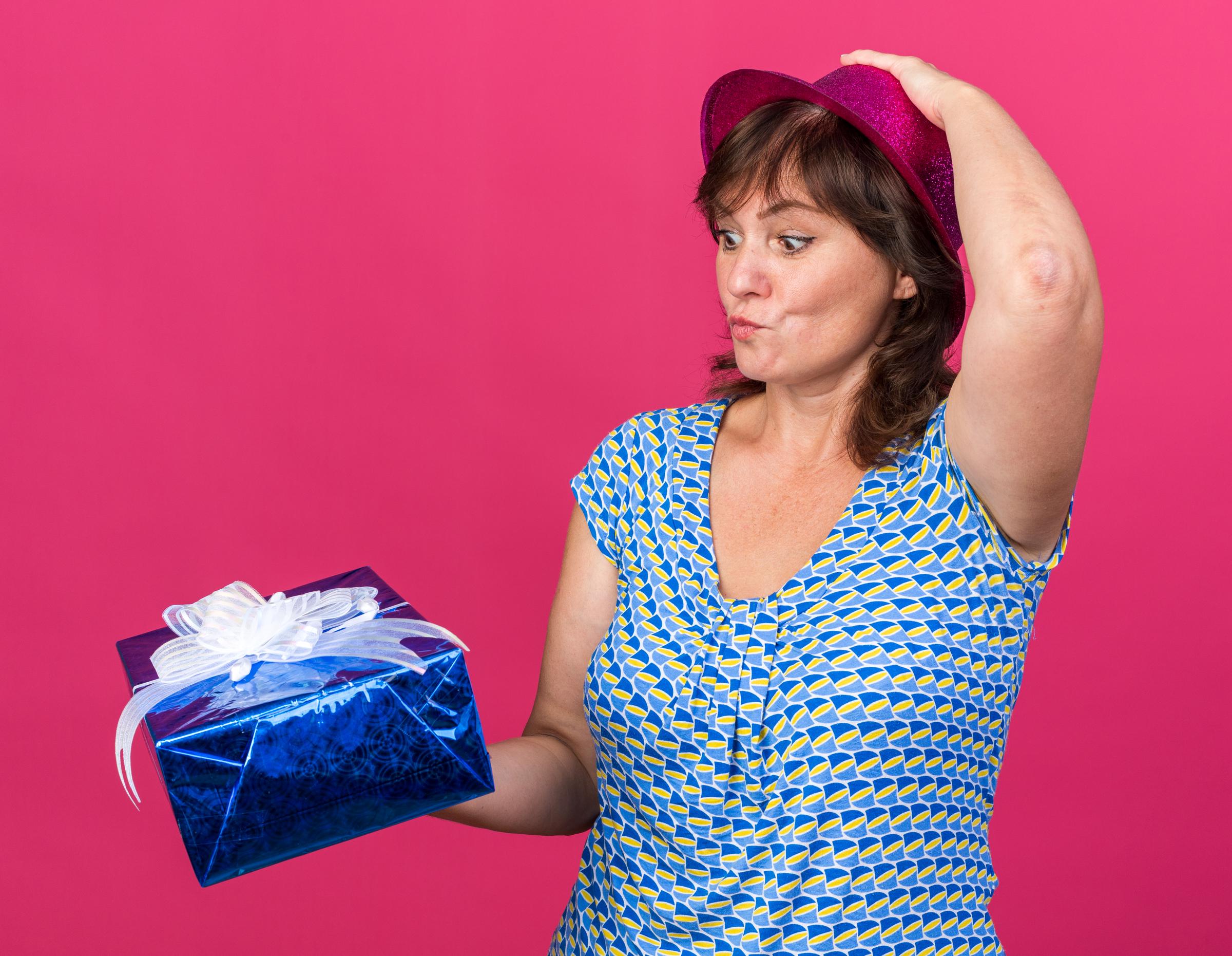 A woman with a present | Source: Freepik