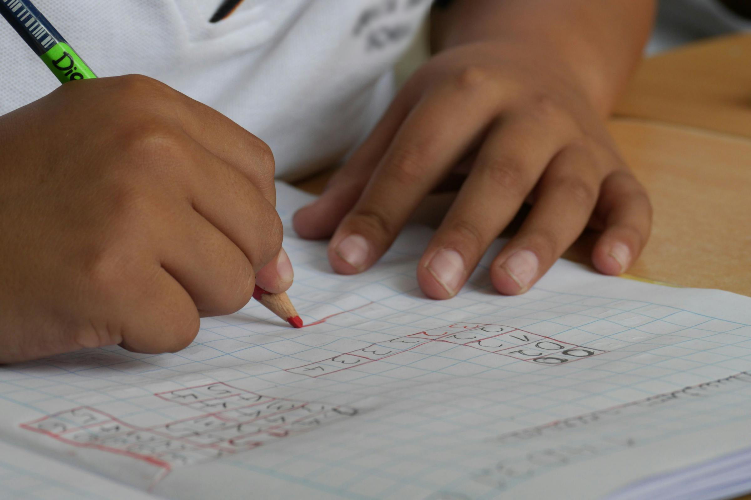 A boy completing his math homework | Source: Pexels