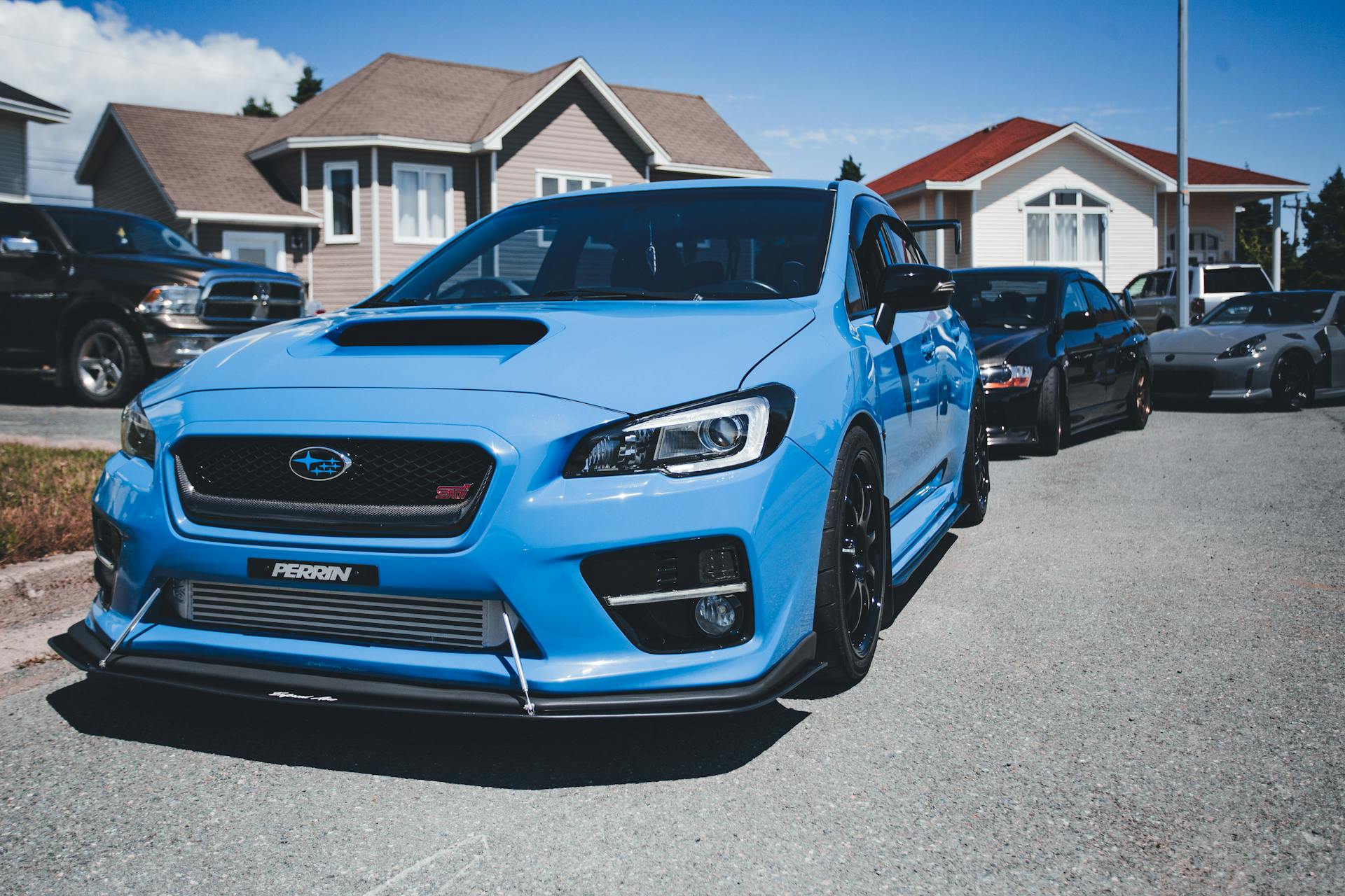 A blue sedan parked at the curb in a suburban neighborhood | Source: Pexels