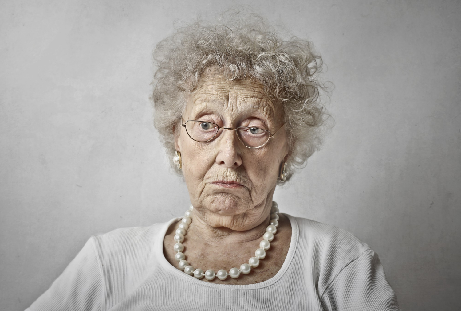 A stunned elderly woman | Source: Freepik