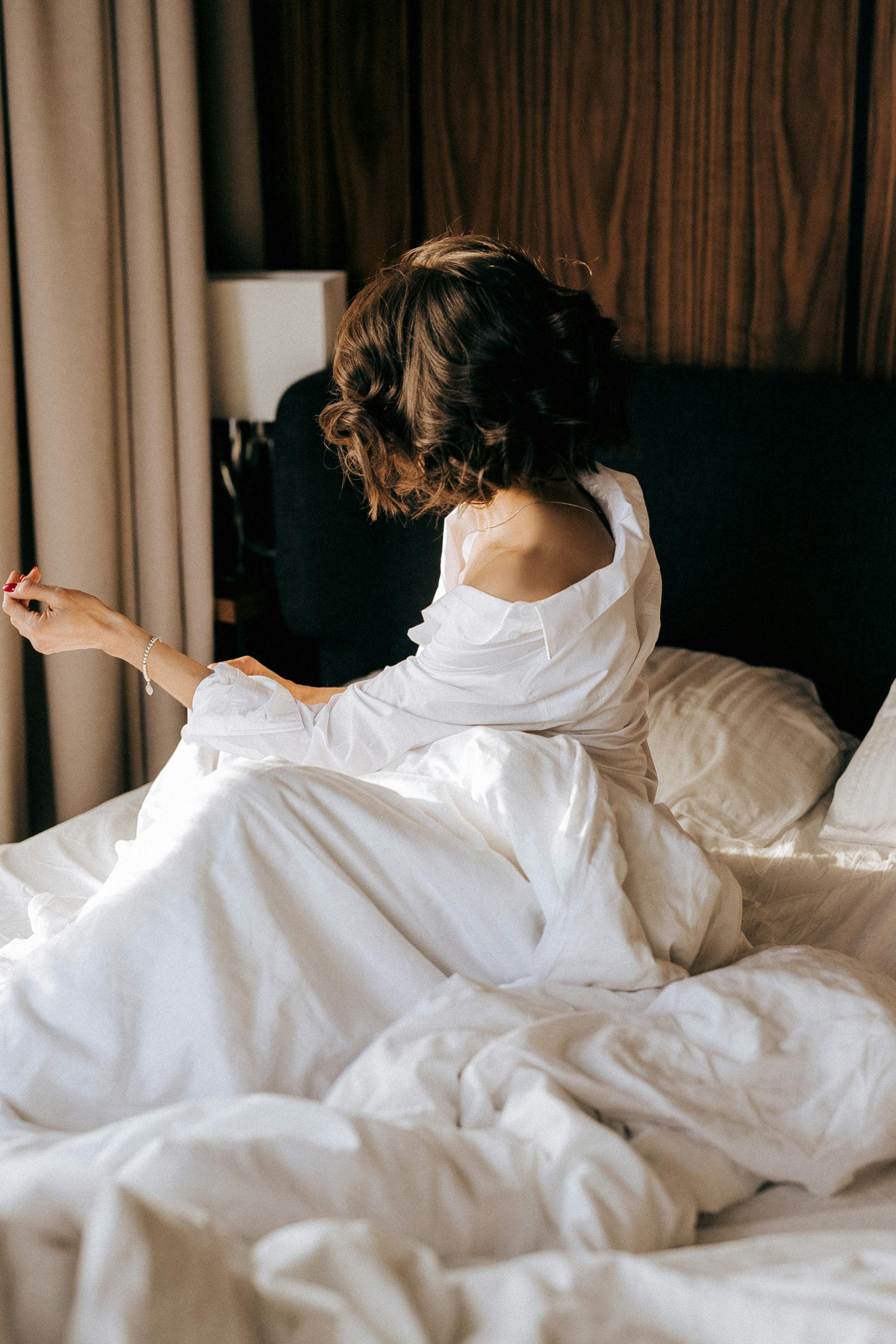 A woman sitting in bed | Source: Pexels