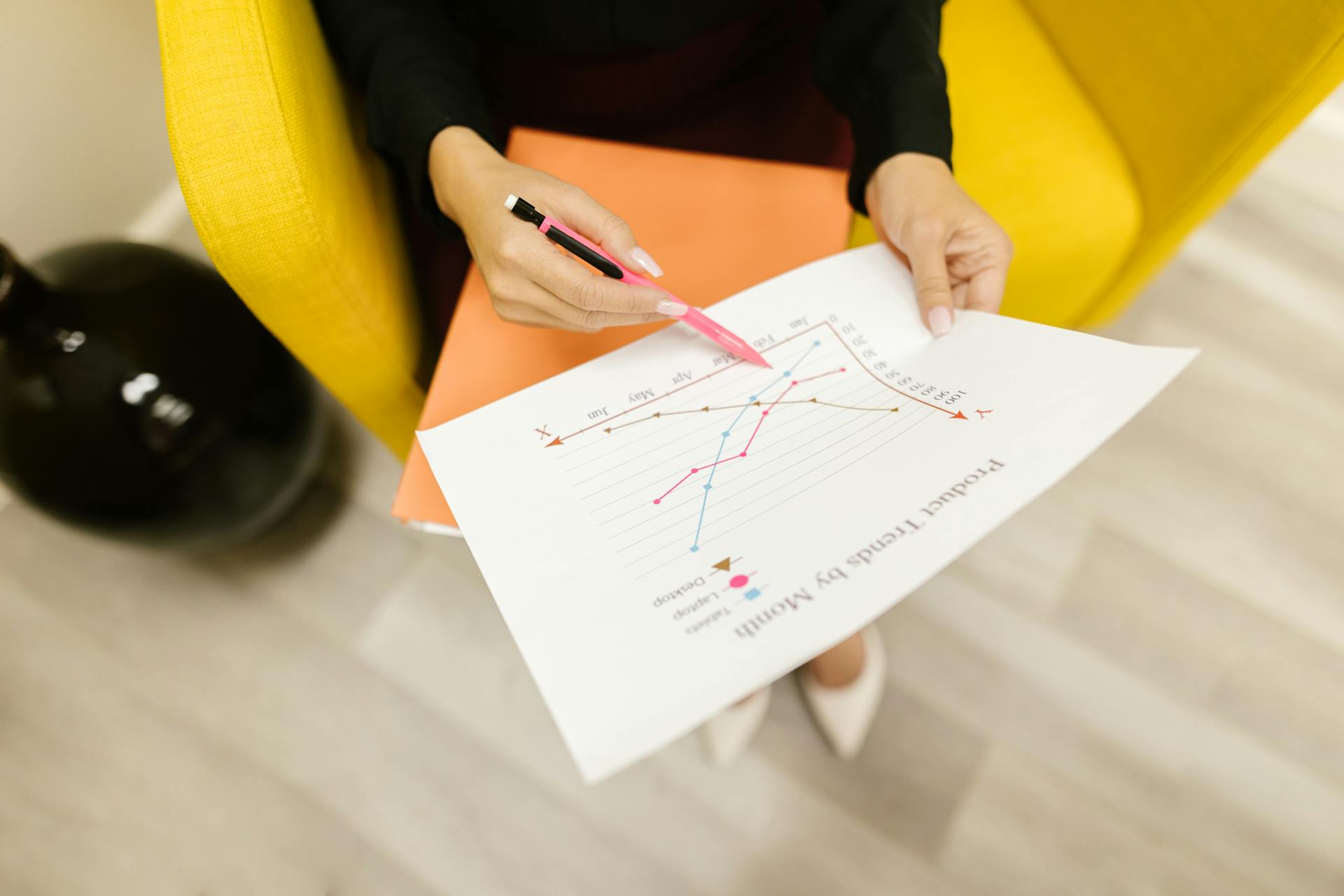 A woman holding a document at work | Source: Pexels