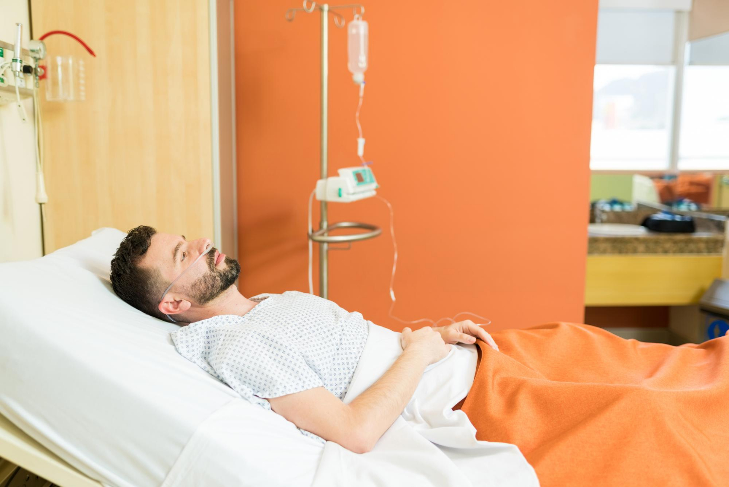A sick man lying in the hospital ward | Source: Freepik