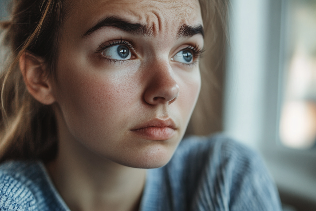 A woman frowning while deep in thought | Source: Midjourney