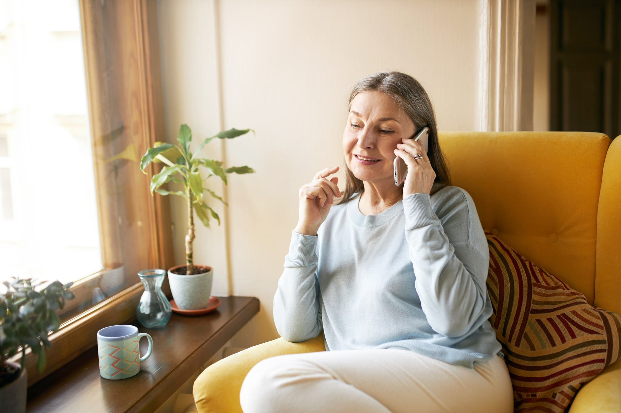 A senior woman talking on the phone | Source: Freepik