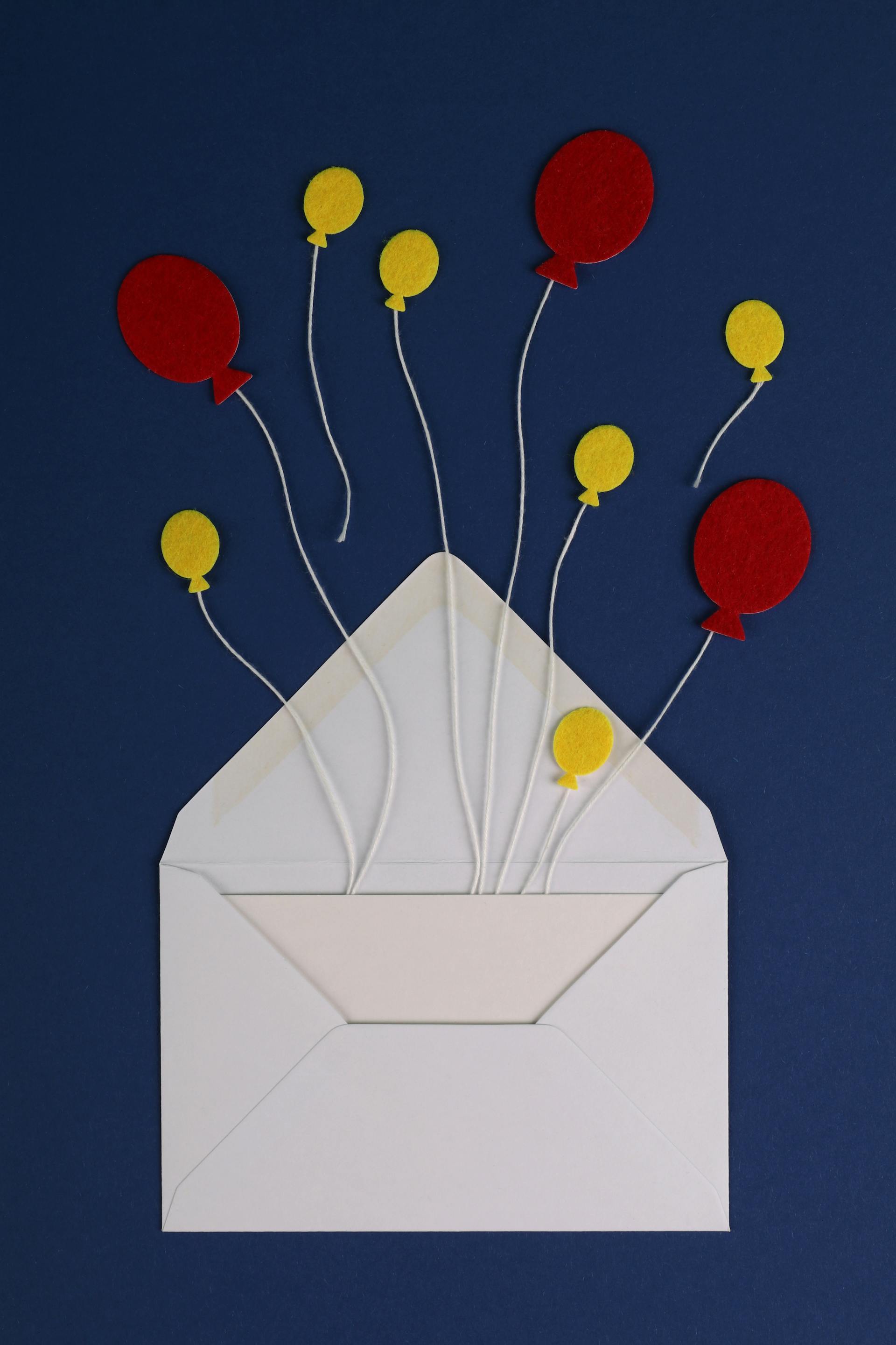 An envelope with paper balloon shapes on strings | Source: Pexels