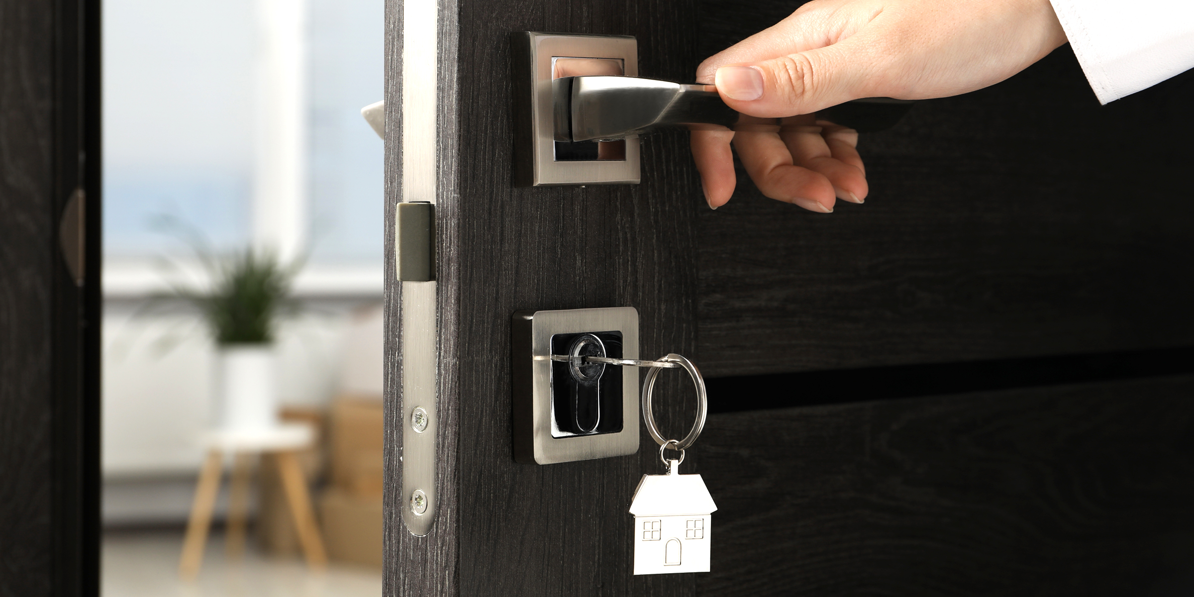 A woman opening a front door | Source: Shutterstock