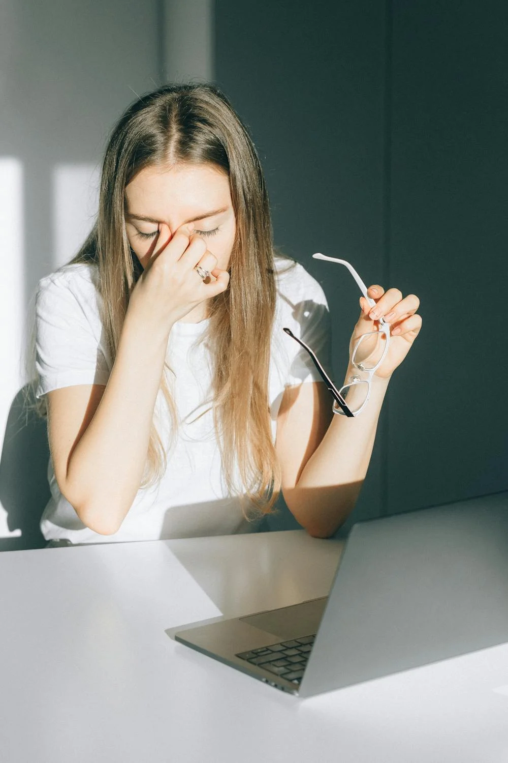 A tired woman rubbing her face | Source: Pexels