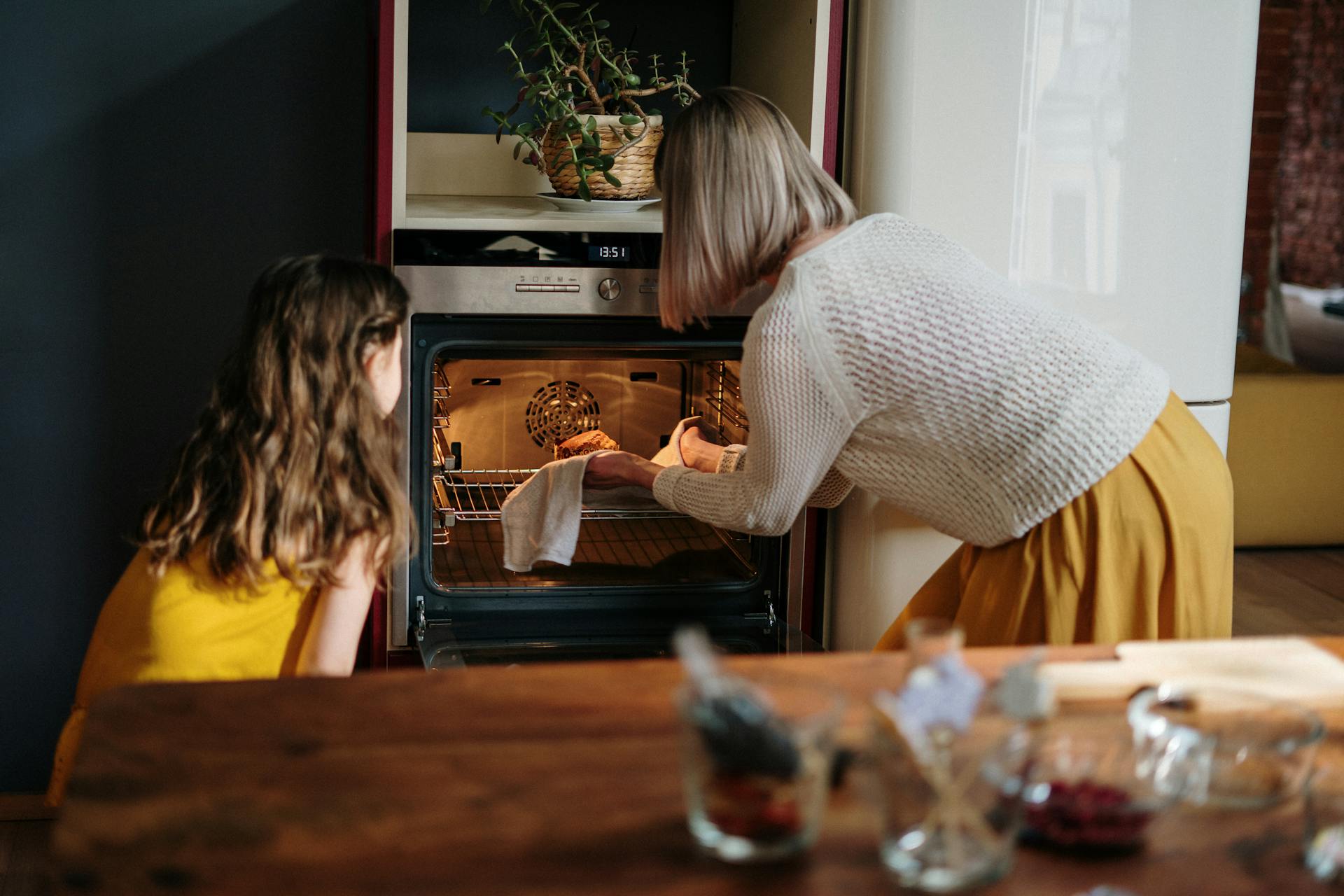 A girl learning to bake from an older woman | Source: Pexels