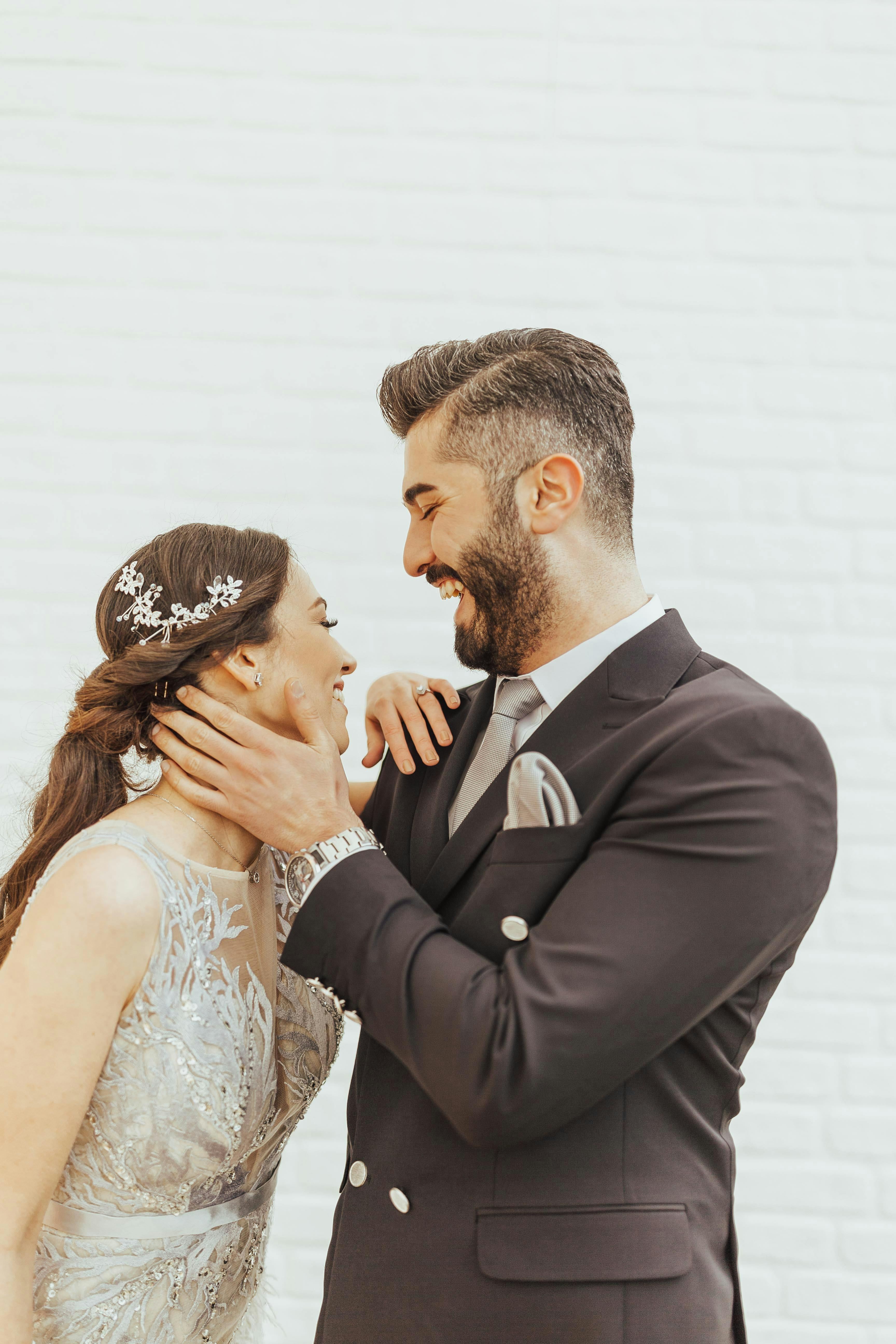 A laughing couple at their wedding | Source: Pexels