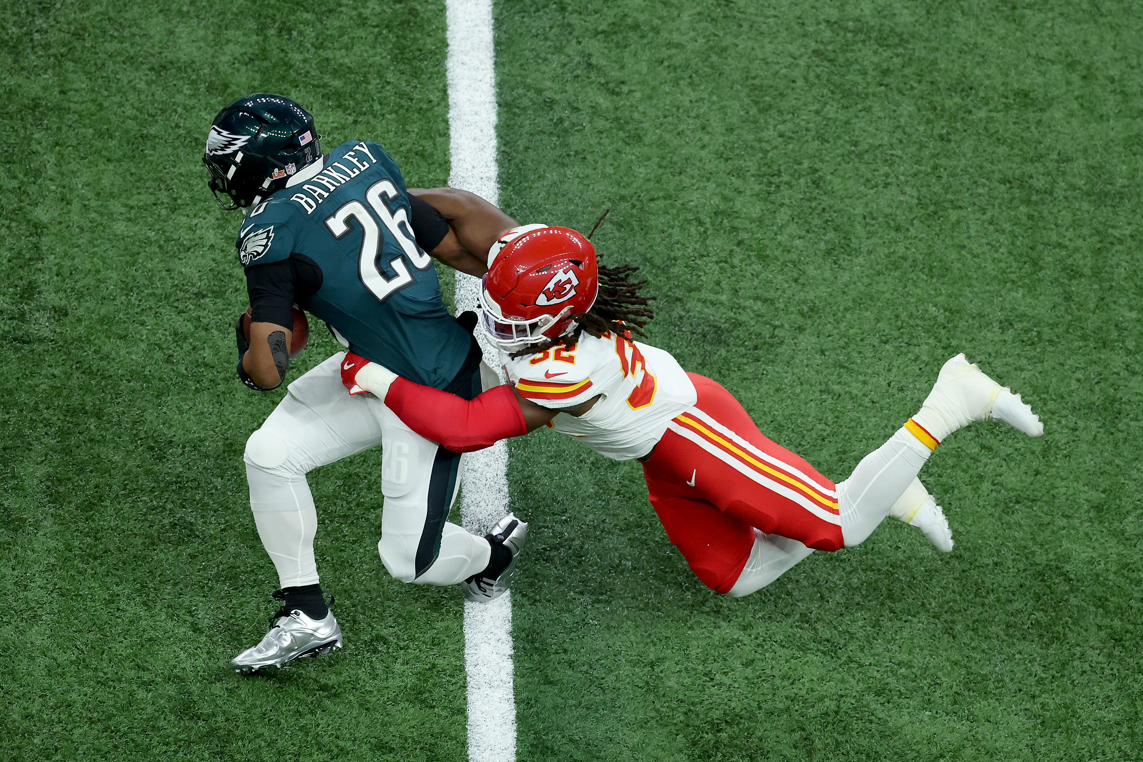 Nick Bolton of the Kansas City Chiefs tackling Saquon Barkley of the Philadelphia Eagles during Super Bowl LIX on February 9, 2025. | Source: Getty Images