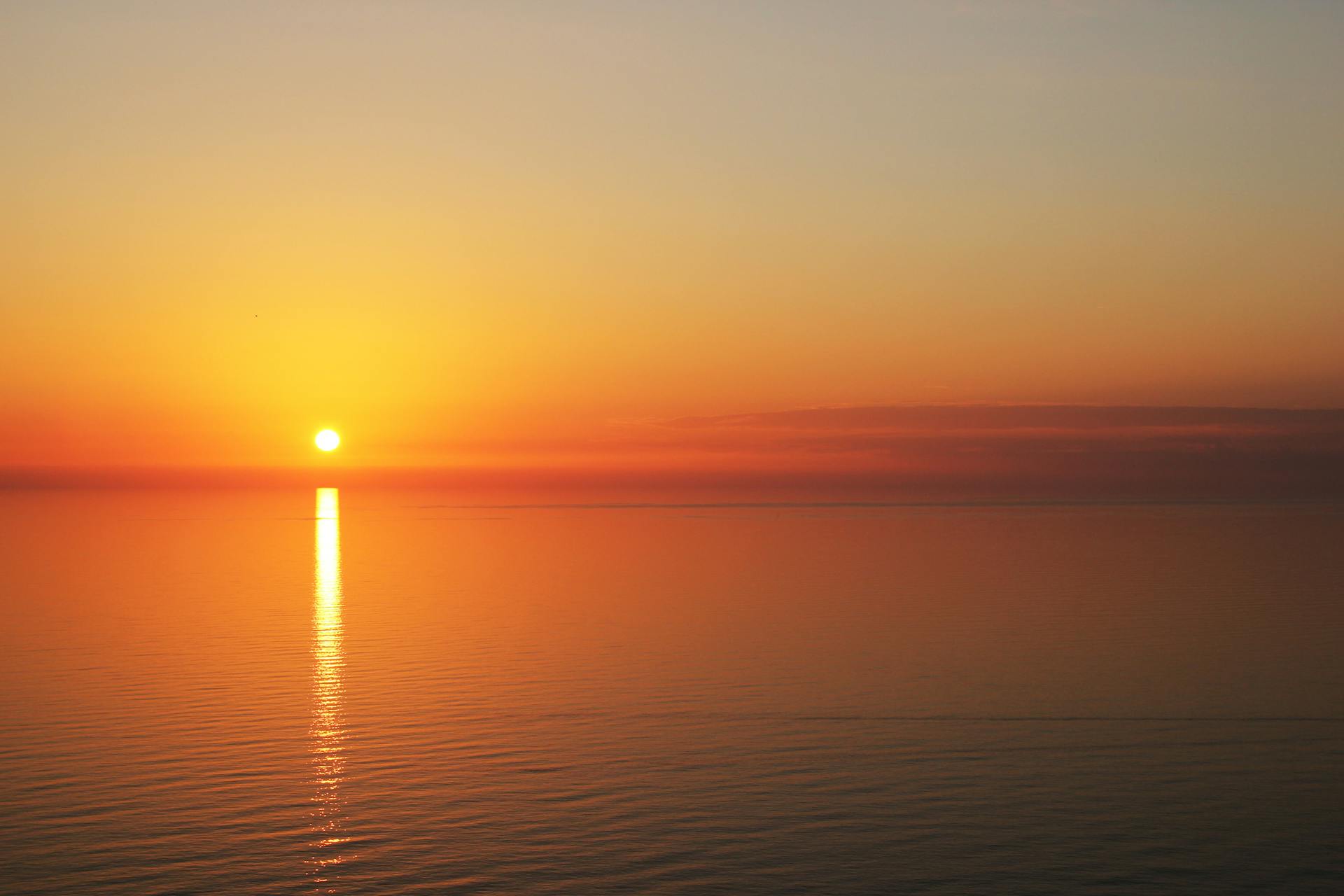 Sunset over a calm ocean | Source: Pexels