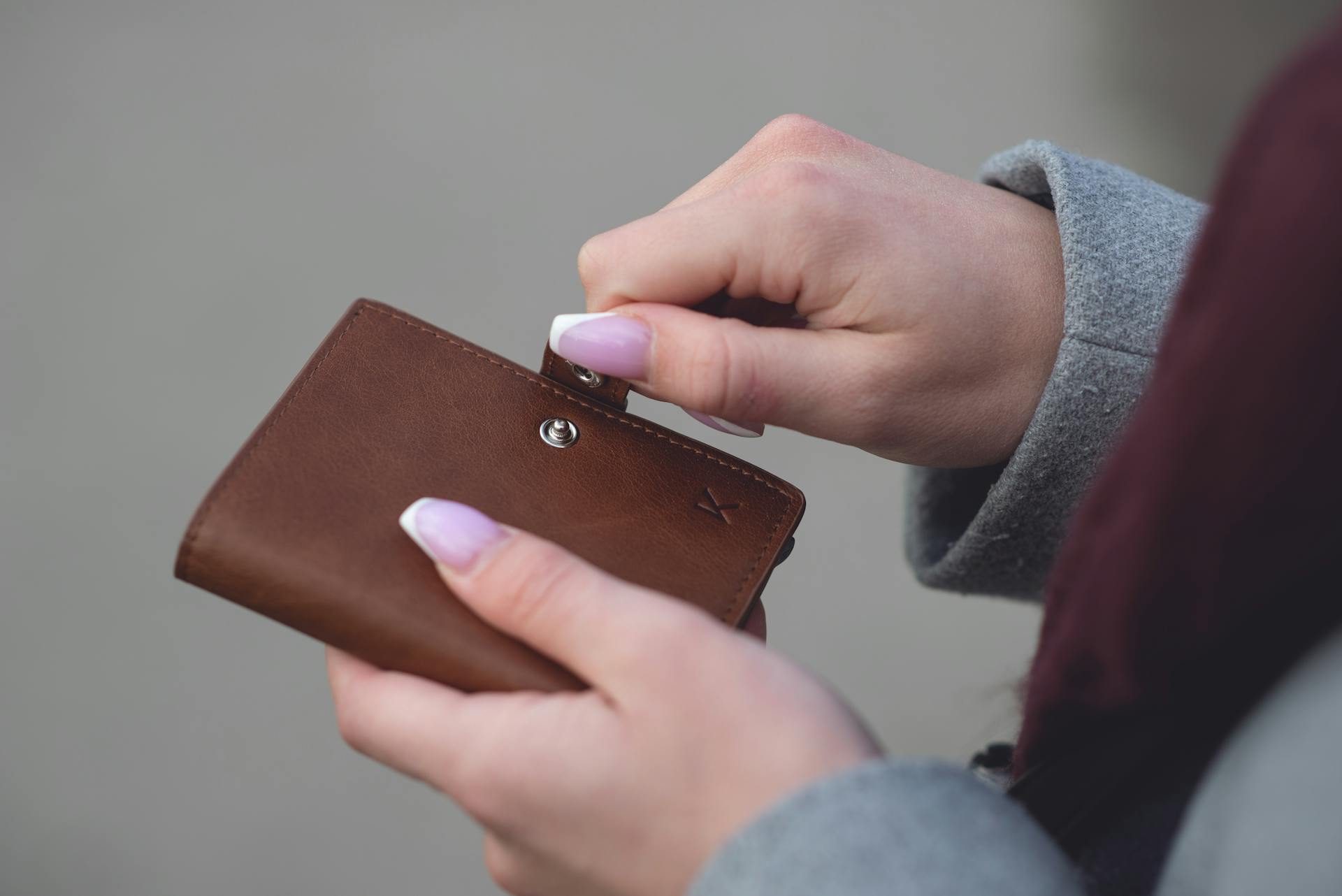 A woman holding her wallet | Source: Pexels