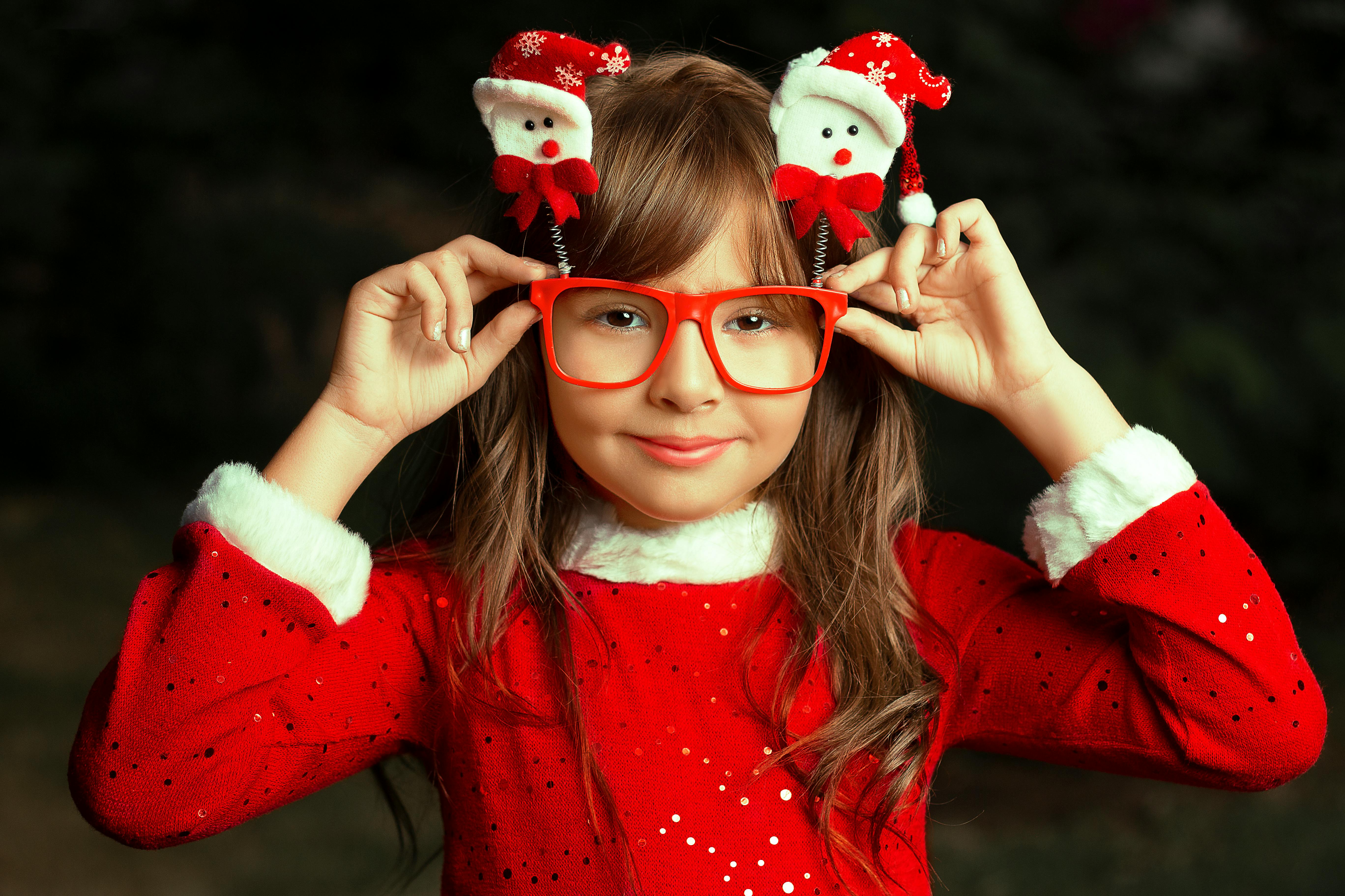 A girl dressed in her Christmas clothes | Source: Pexels