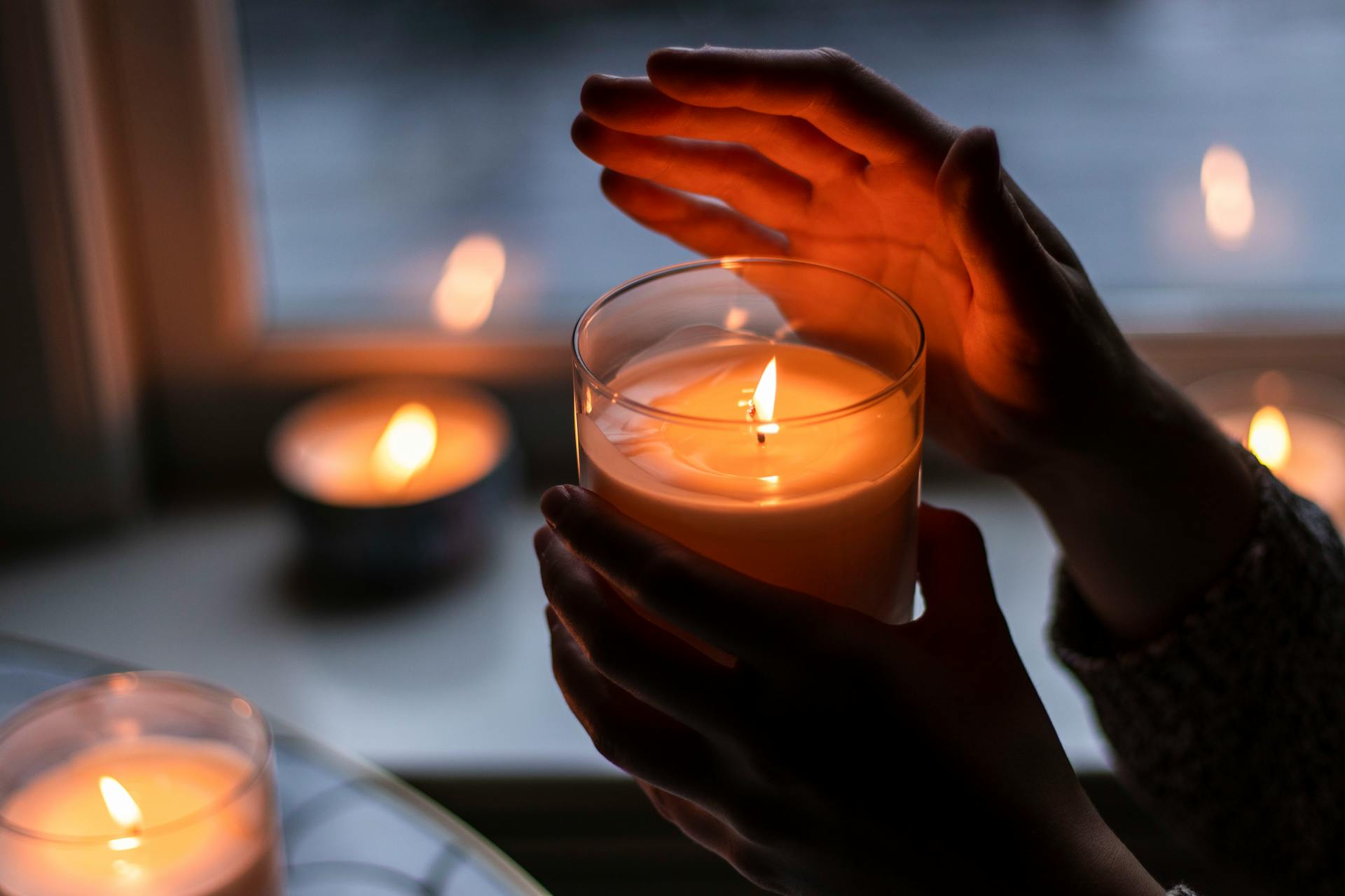 A woman holding a candle | Source: Pexels