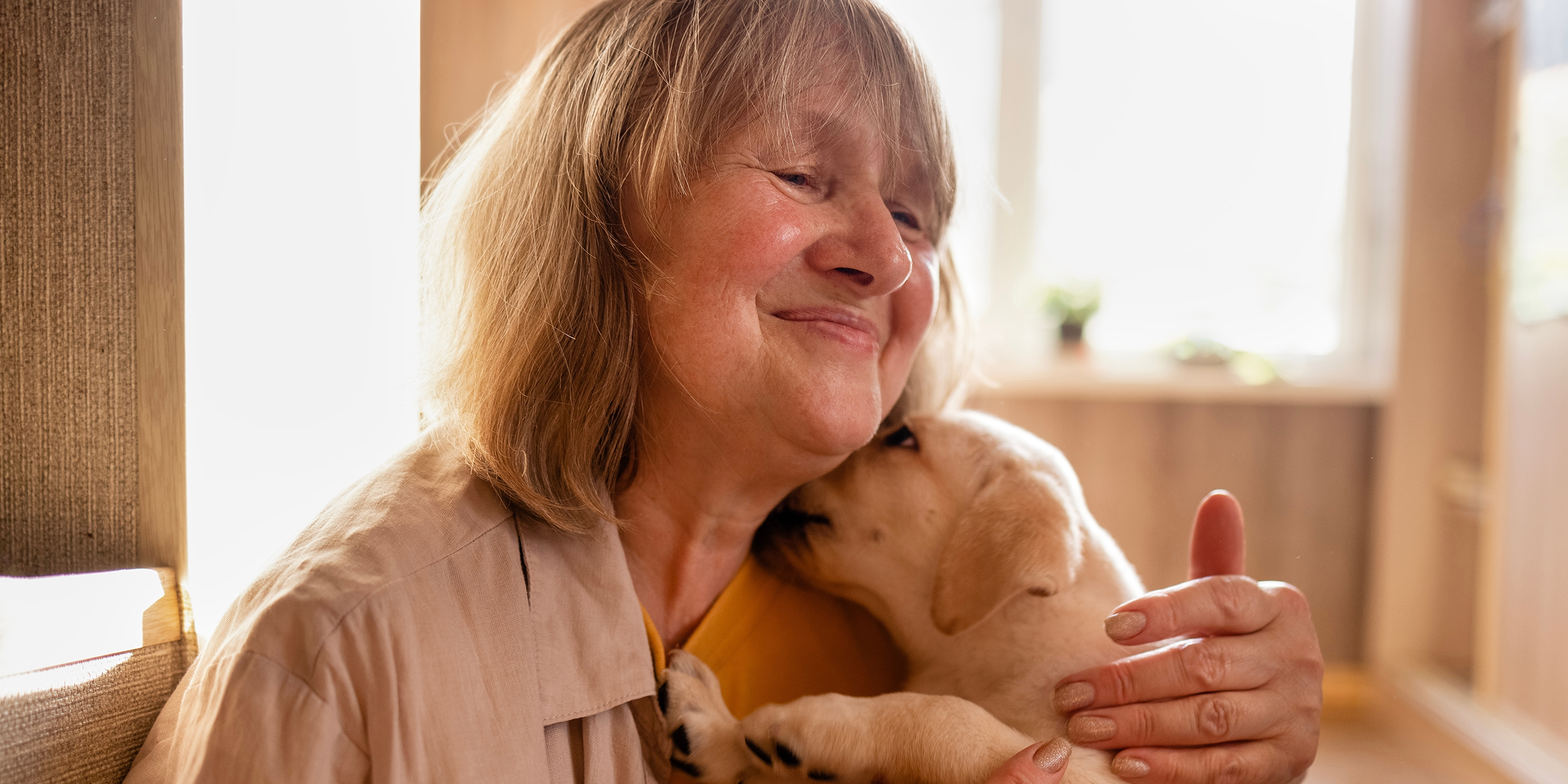 A mature woman cuddling a dog | Source: Shutterstock