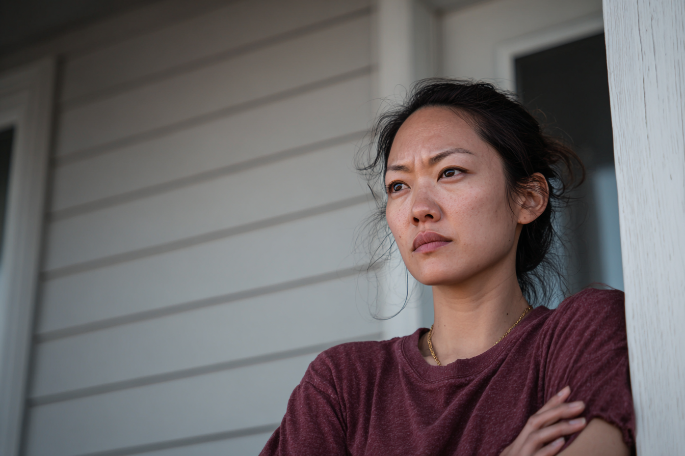 An annoyed woman standing on a porch | Source: Midjourney