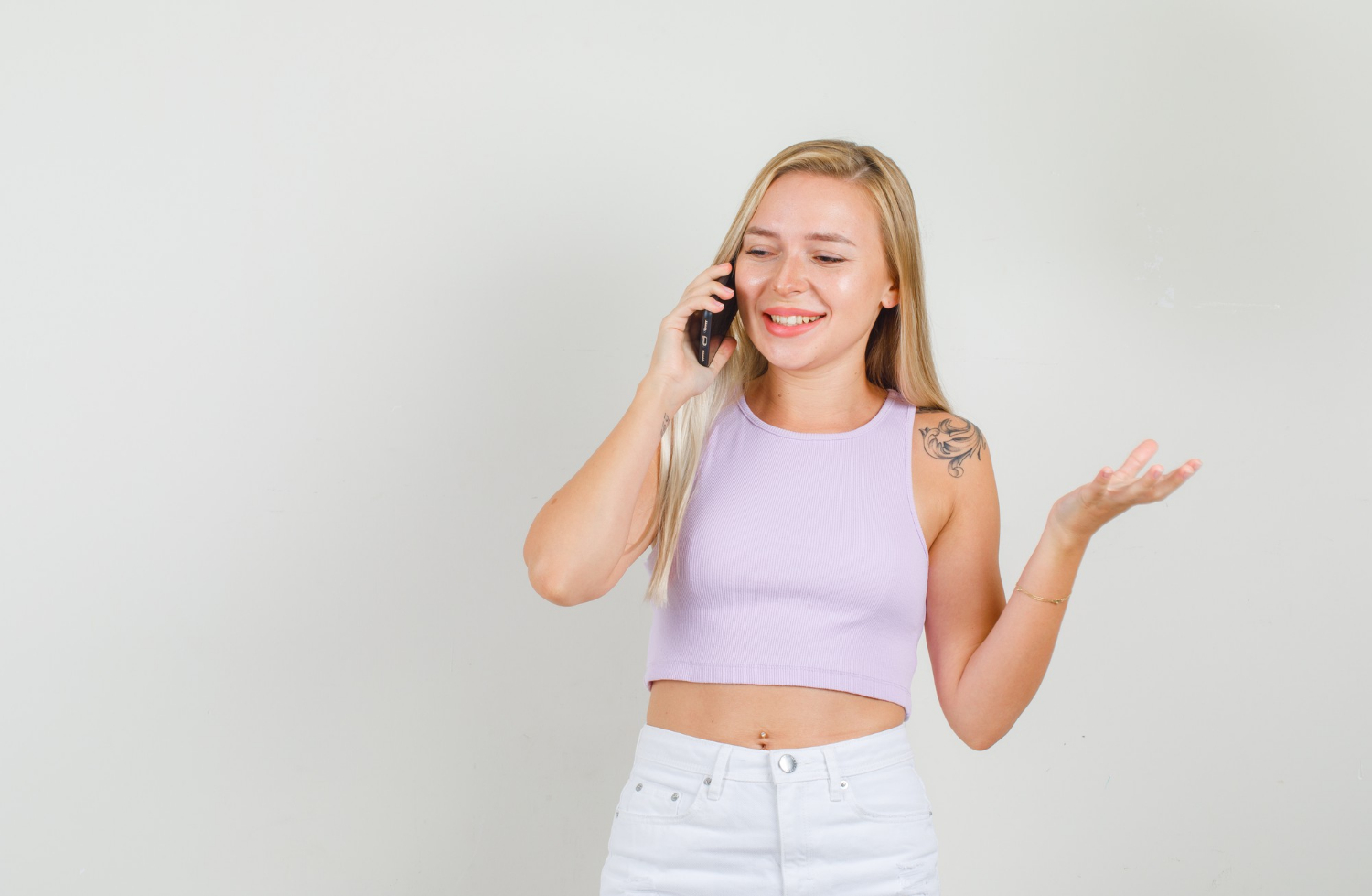 A young woman talking on the phone | Source: Freepik