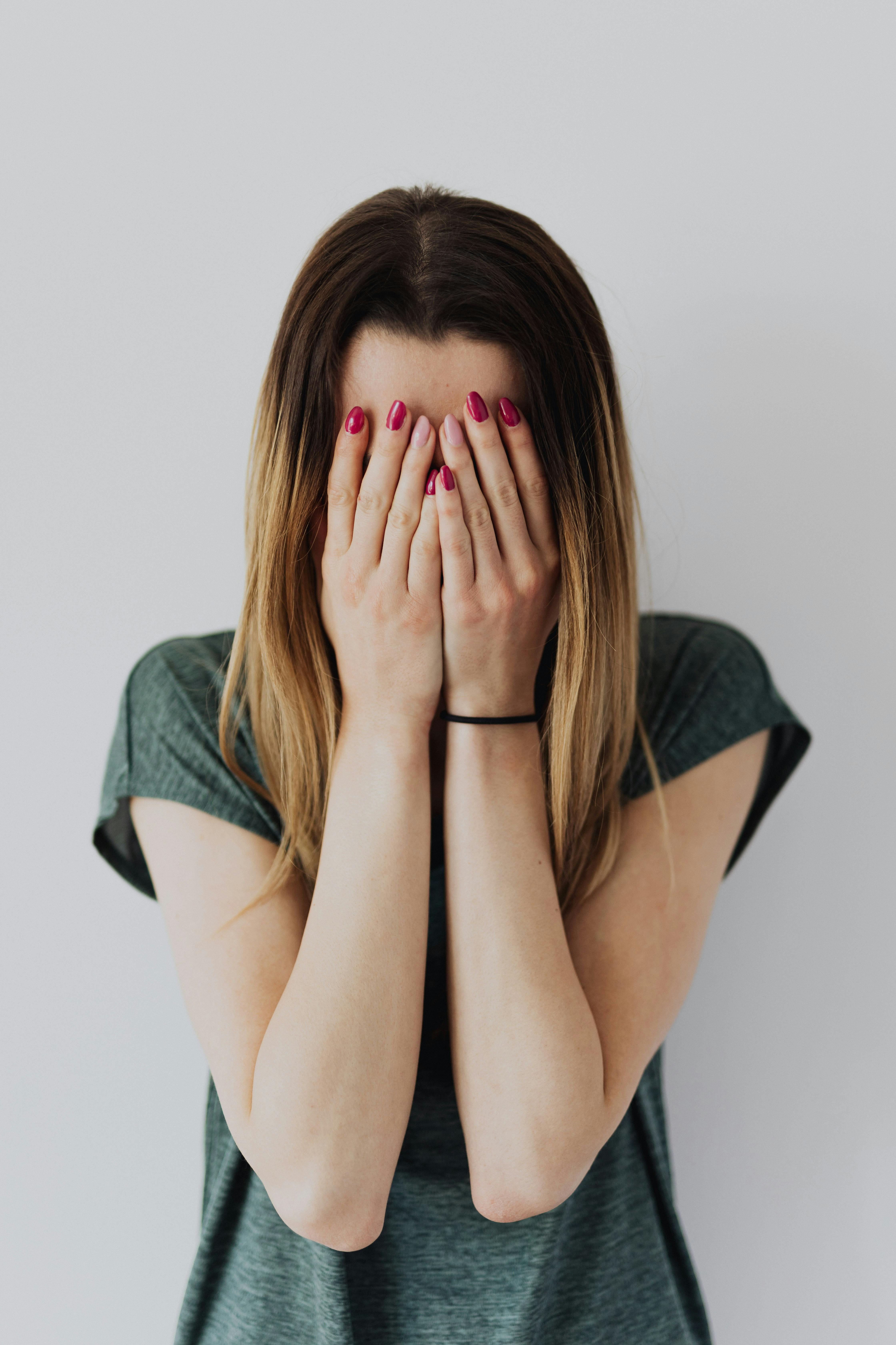 A woman covering her face while crying | Source: Pexels