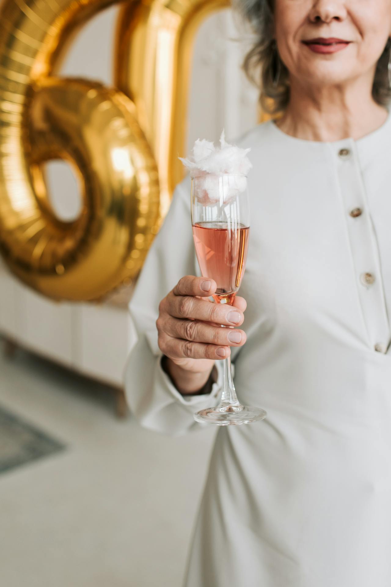 A woman holding a drink in a clear glass | Source: Pexels