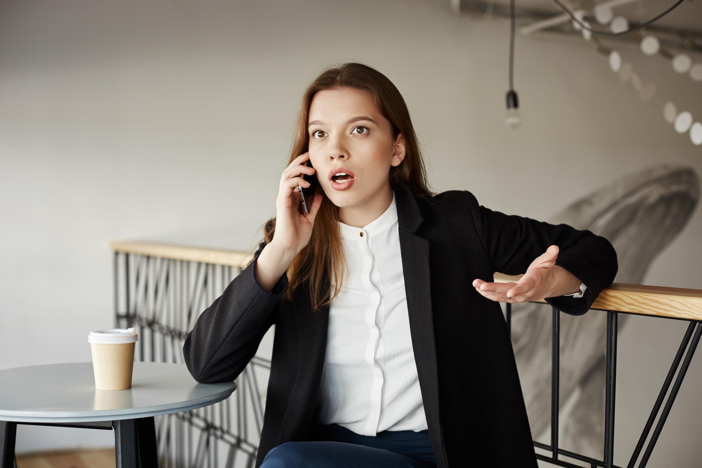 An upset woman on a call | Source: Freepik