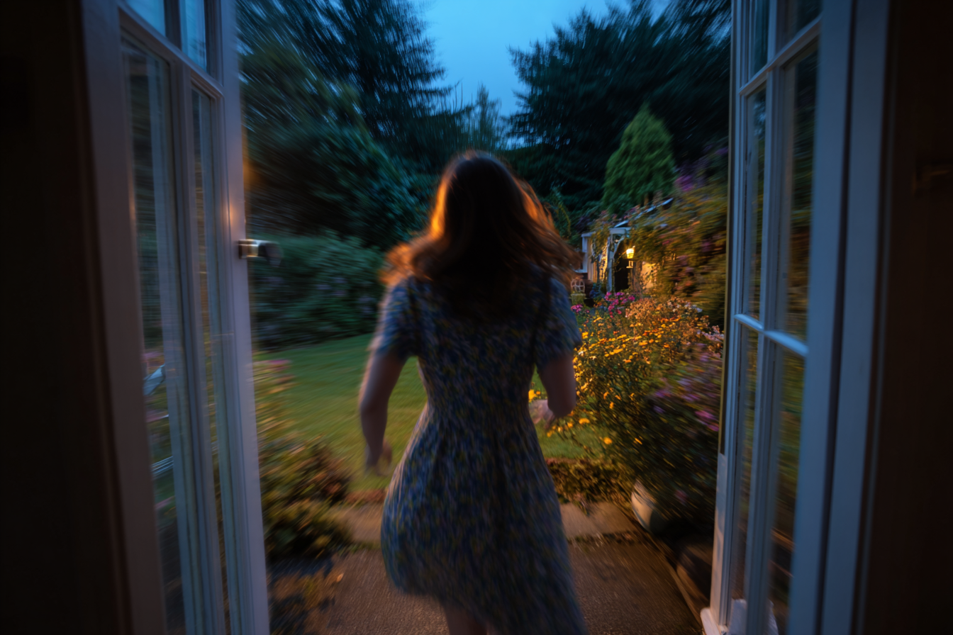 A woman running through a door | Source: Midjourney