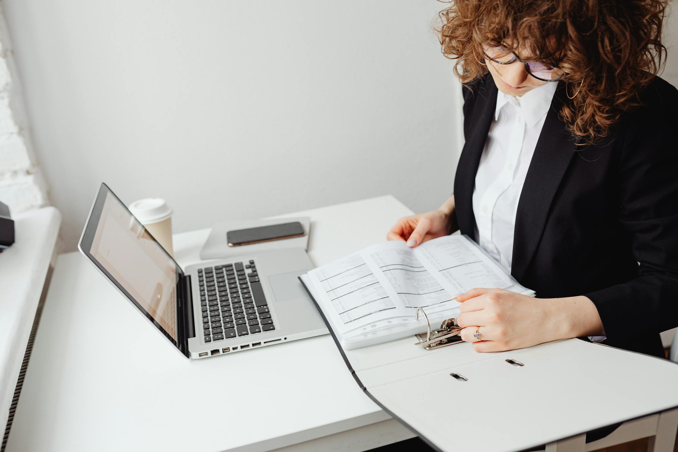 A woman looking through documents | Source: Pexels