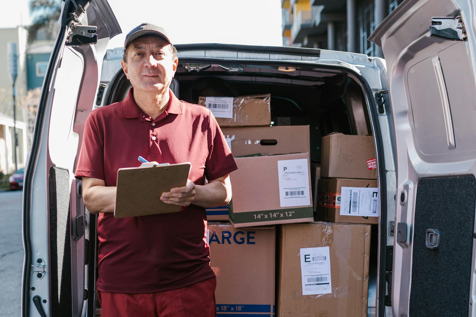 A delivery driver with a van filled with packages | Source: Pexels