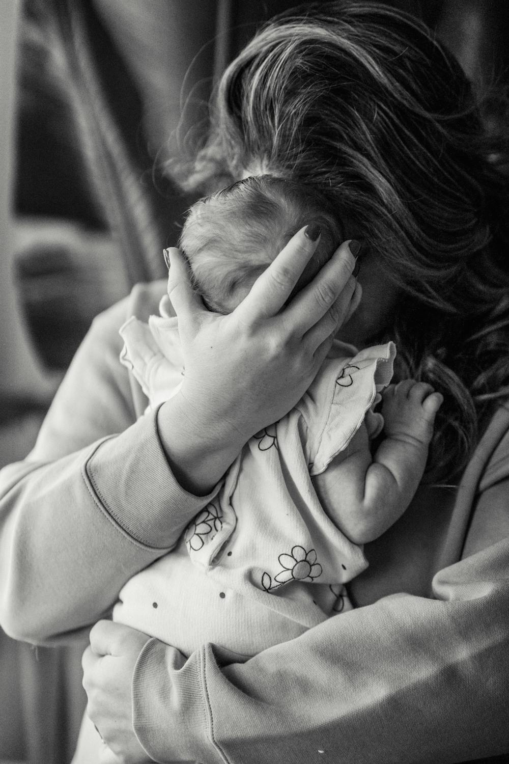 A woman hugging her newborn | Source: Pexels