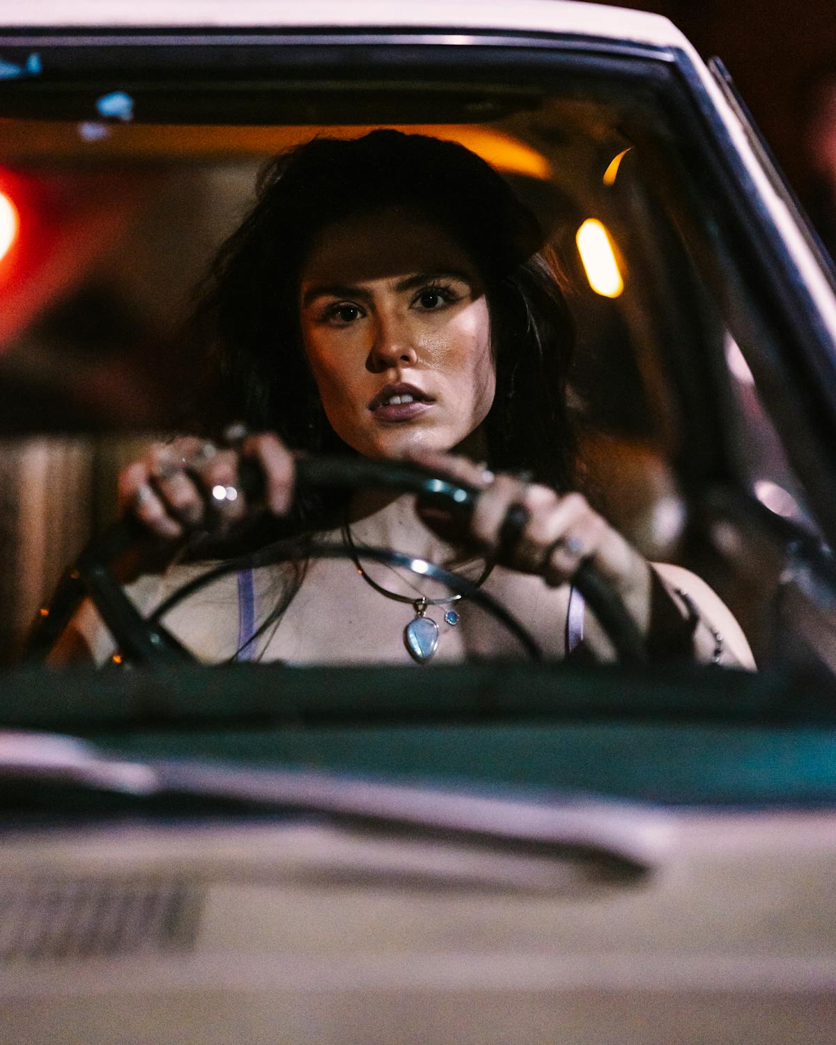 A serious woman in a car at night | Source: Pexels