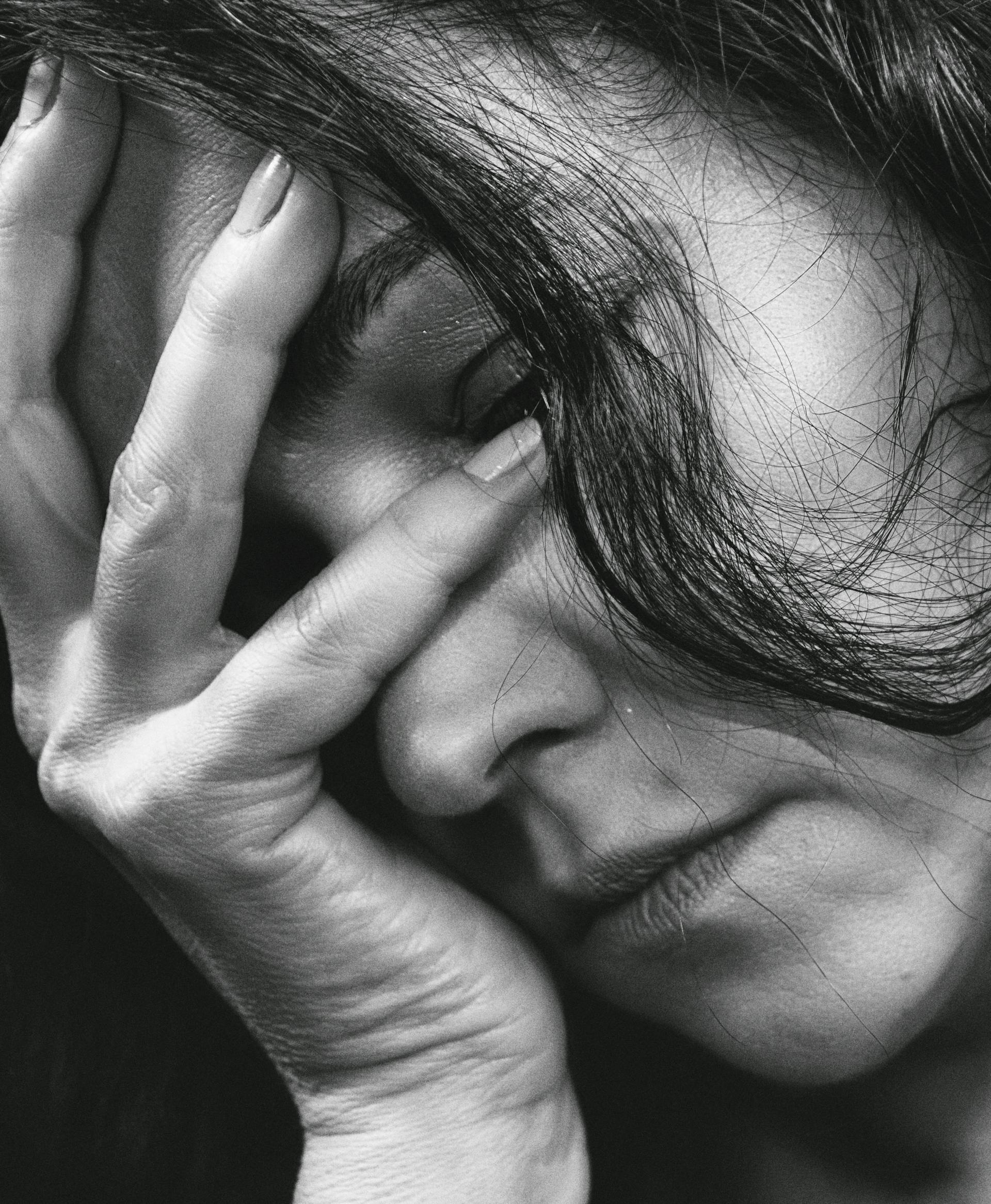 A worried woman resting her head in one hand | Source: Pexels