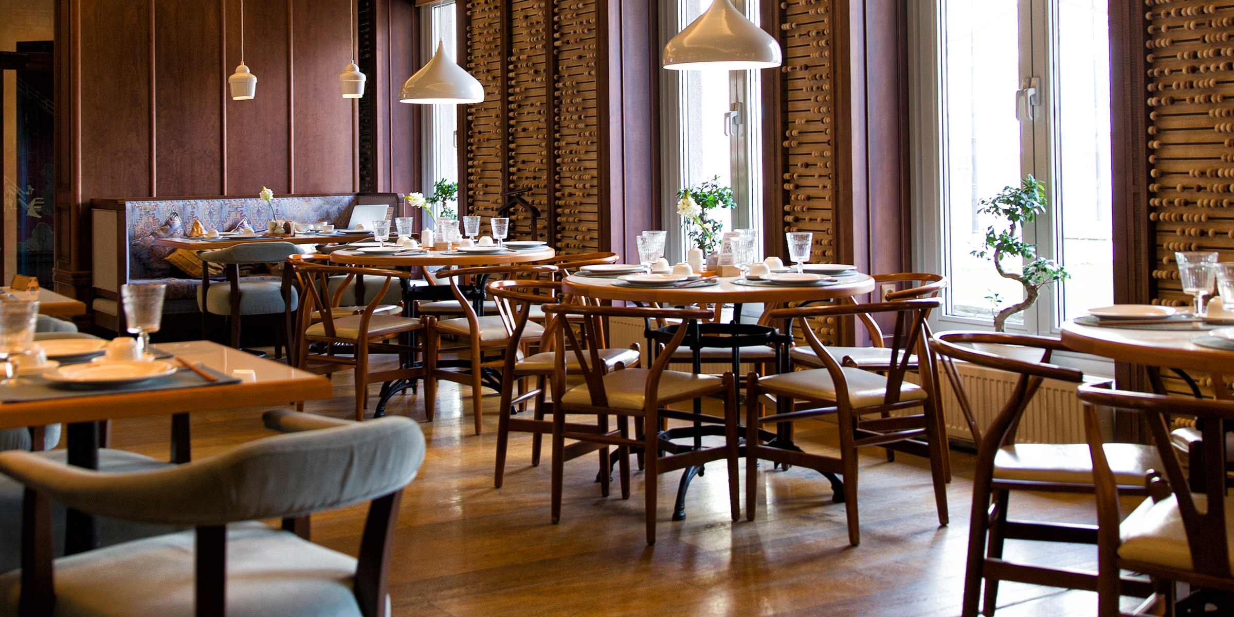 An elegant restaurant with neatly set tables and warm light | Source: Shutterstock