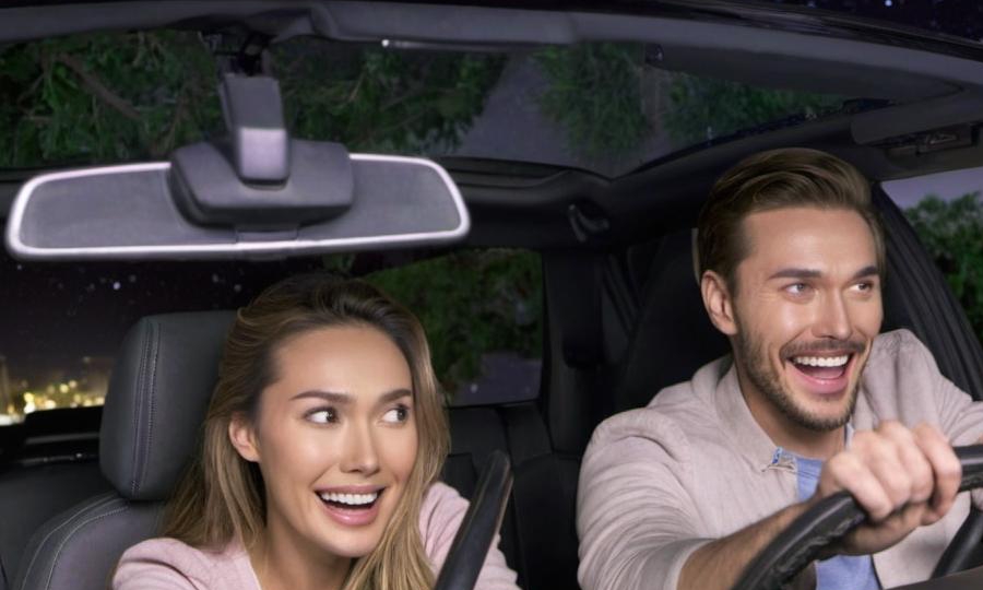 A happy-looking man and woman driving in a car | Source: Midjourney