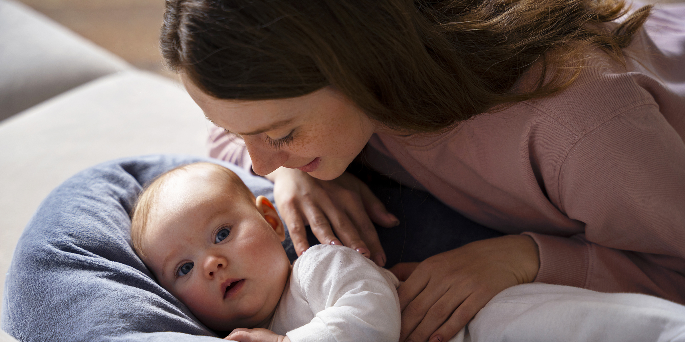 A woman tucking a child in | Source: Freepik